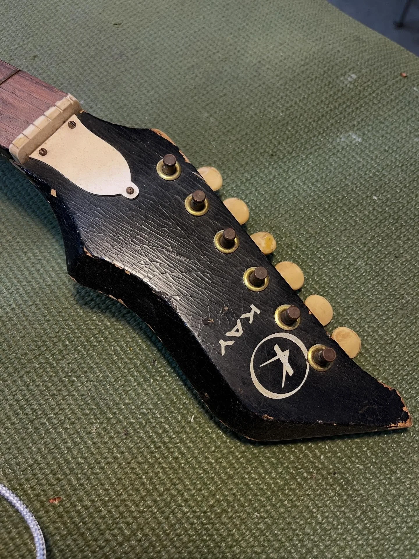 An upcoming personal project; I&rsquo;m going to rehab this very abused &ldquo;bush axe&rdquo; headstock Kay into something usable and a little weird. Also thinking I&rsquo;m just going to stabilize the damaged finish instead of removing it.
#kayguit