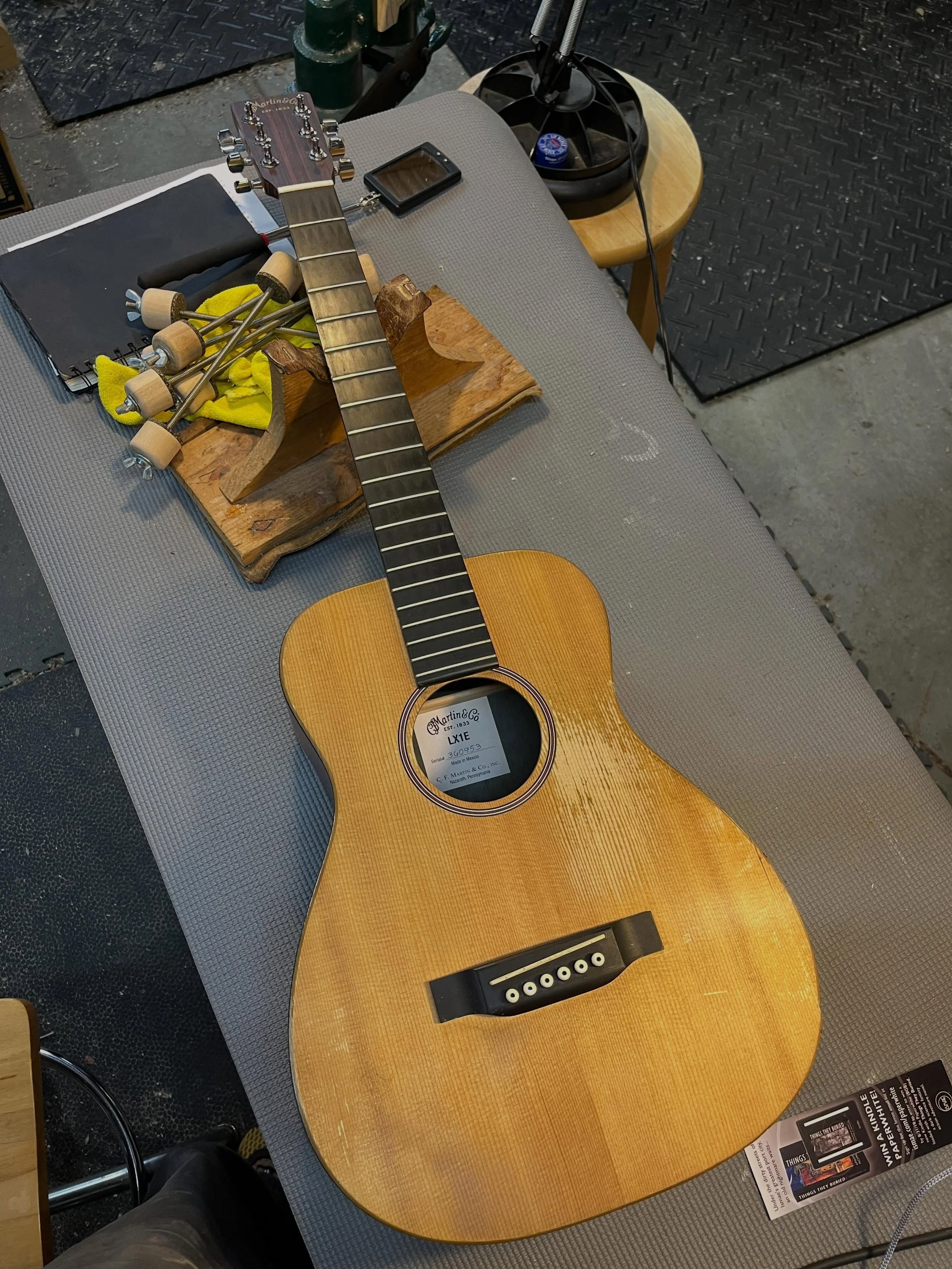 Another Martin X-series on the bench. Multiple cracks and seam separations. A road warrior that&rsquo;s made its player $ enough to bring it back from the brink.