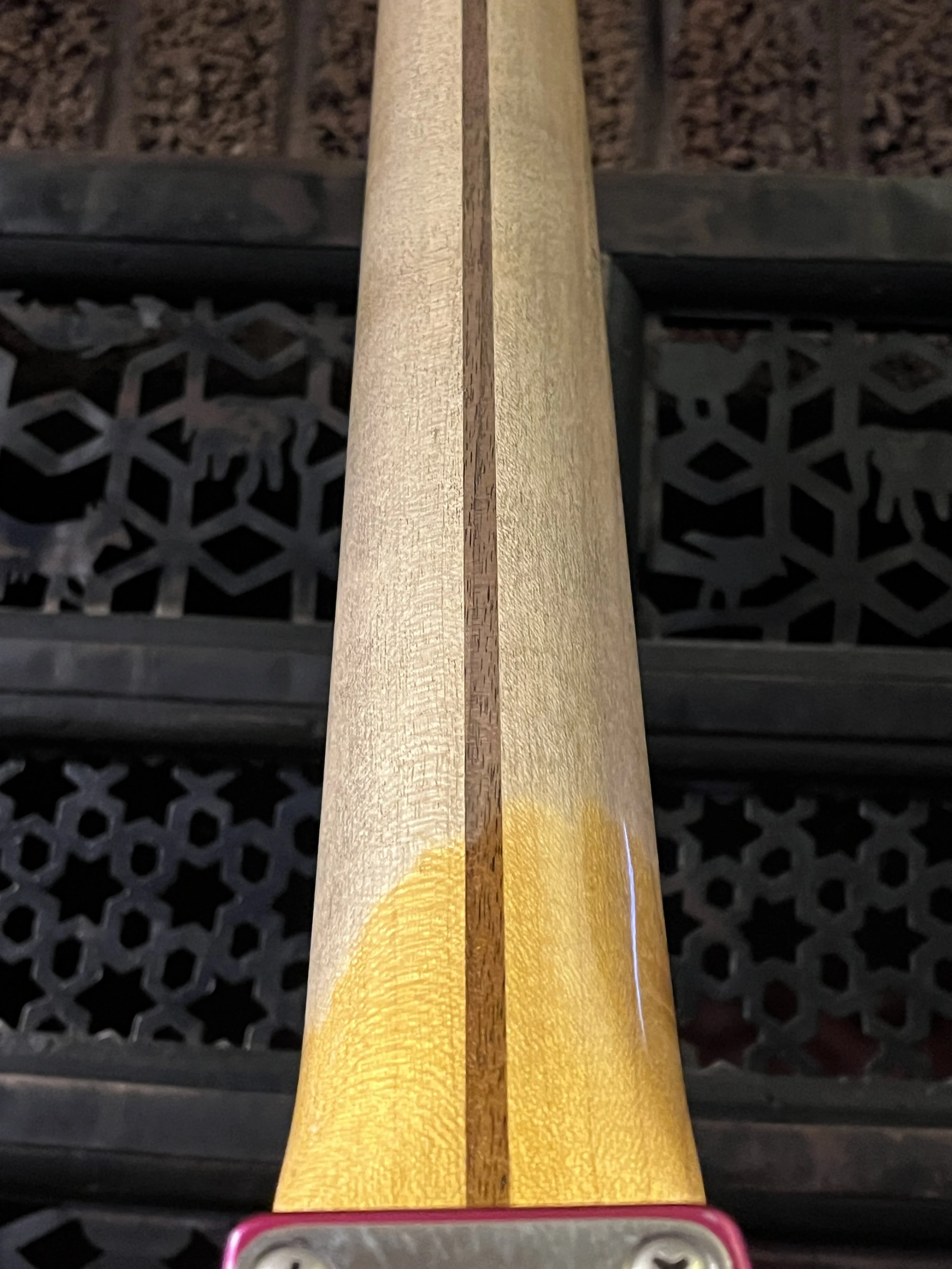 The back of the neck of a reliced pink paisley Fender Telecaster Thinline 50s.