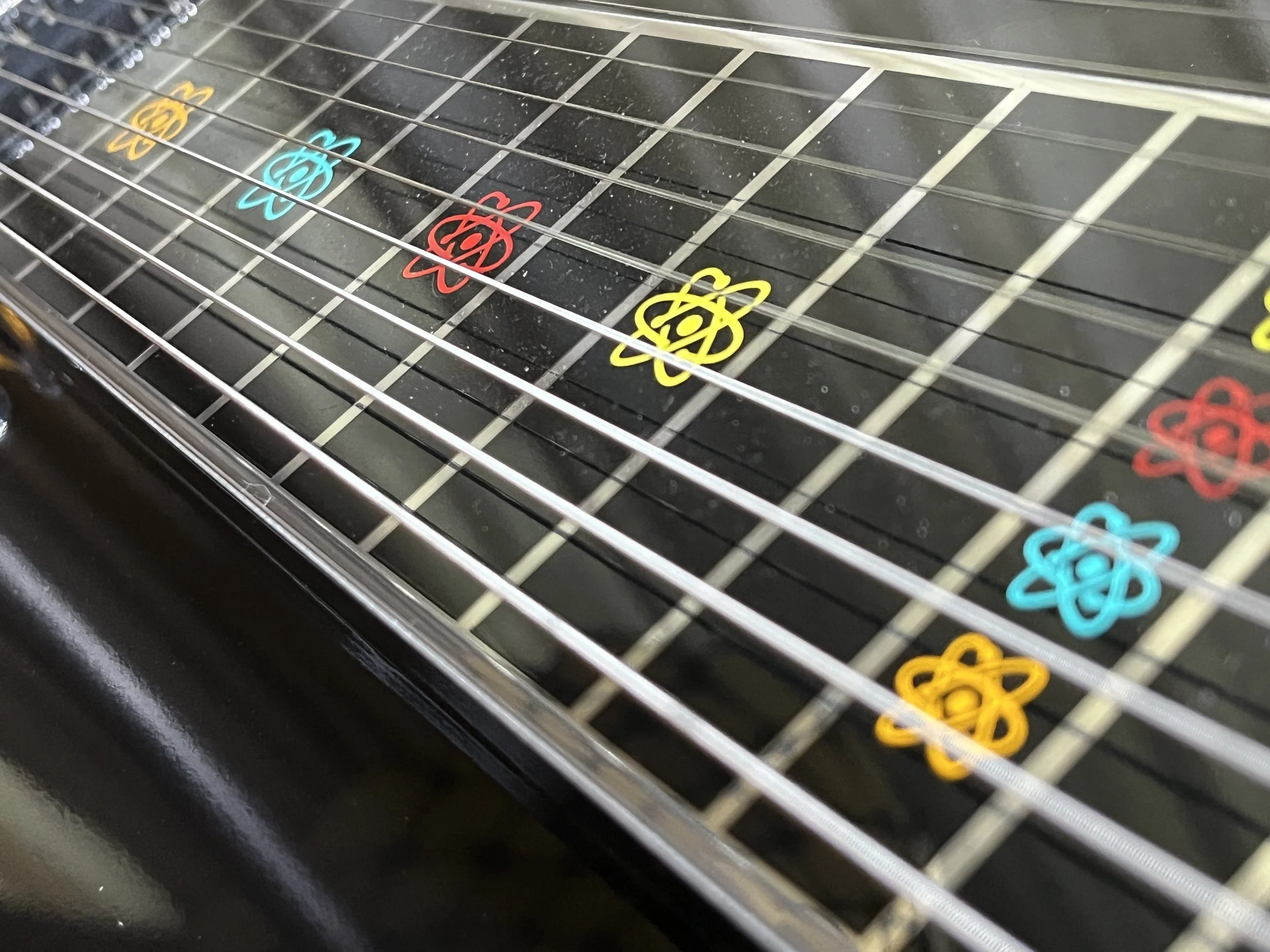 Emmons Resound'65 S10 Pedal Steel fret markers in retro atomic design in turquoise, red, yellow, and orange.