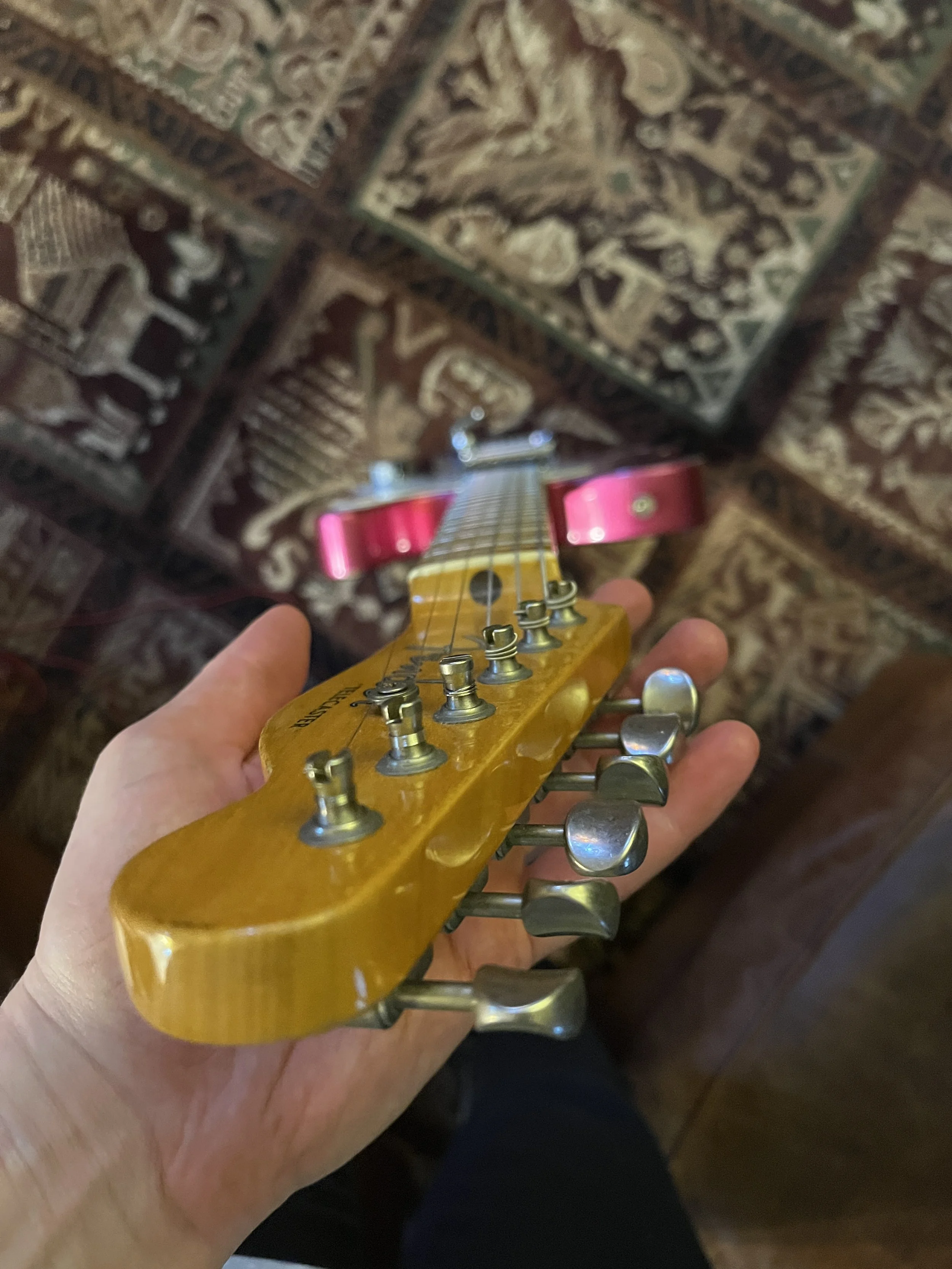 Looking down the fingerboard of a reliced pink paisley Fender Telecaster Thinline 50s.