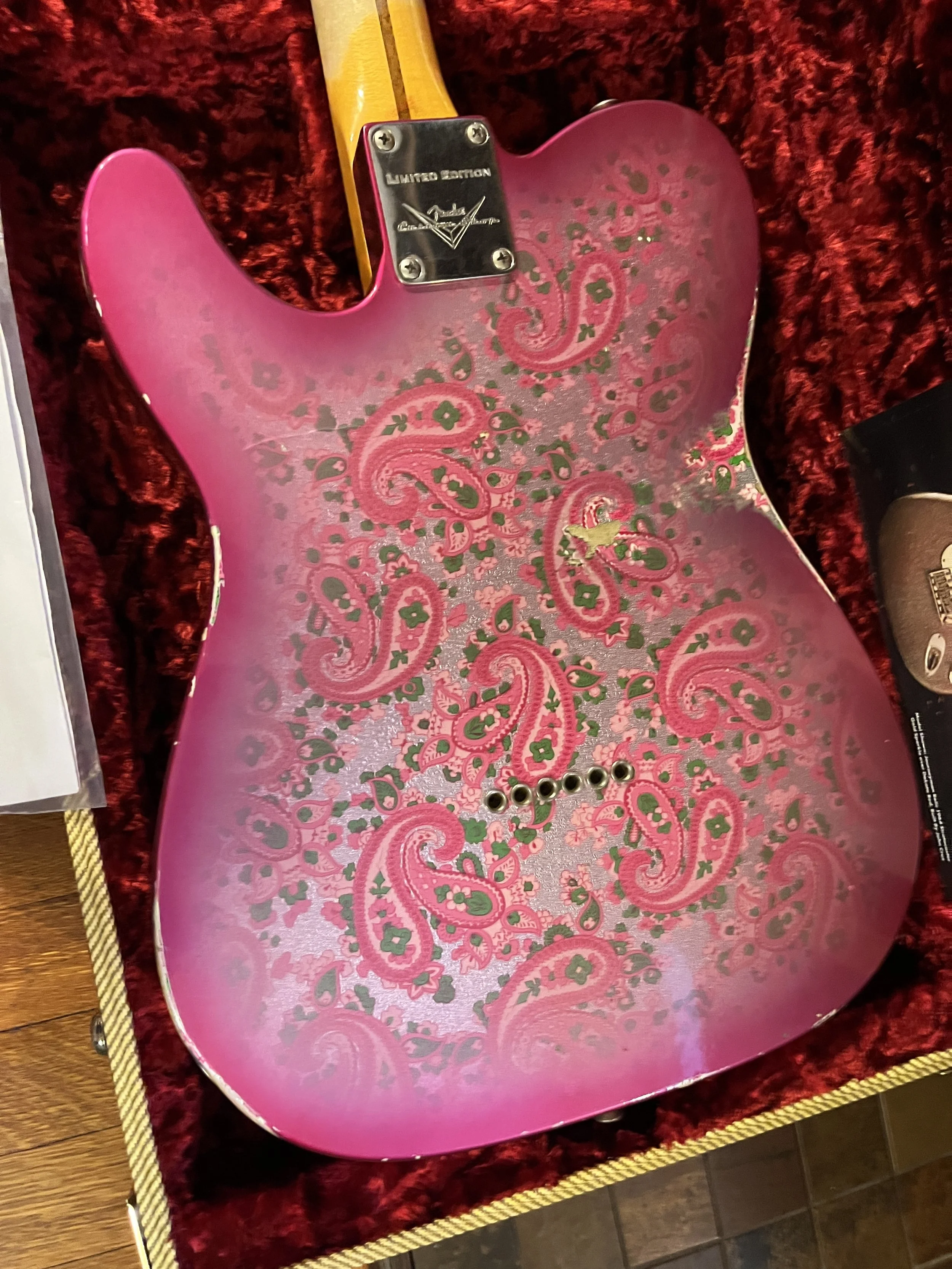 The back of a reliced pink paisley Fender Telecaster Thinline 50s in it's hardshell case.