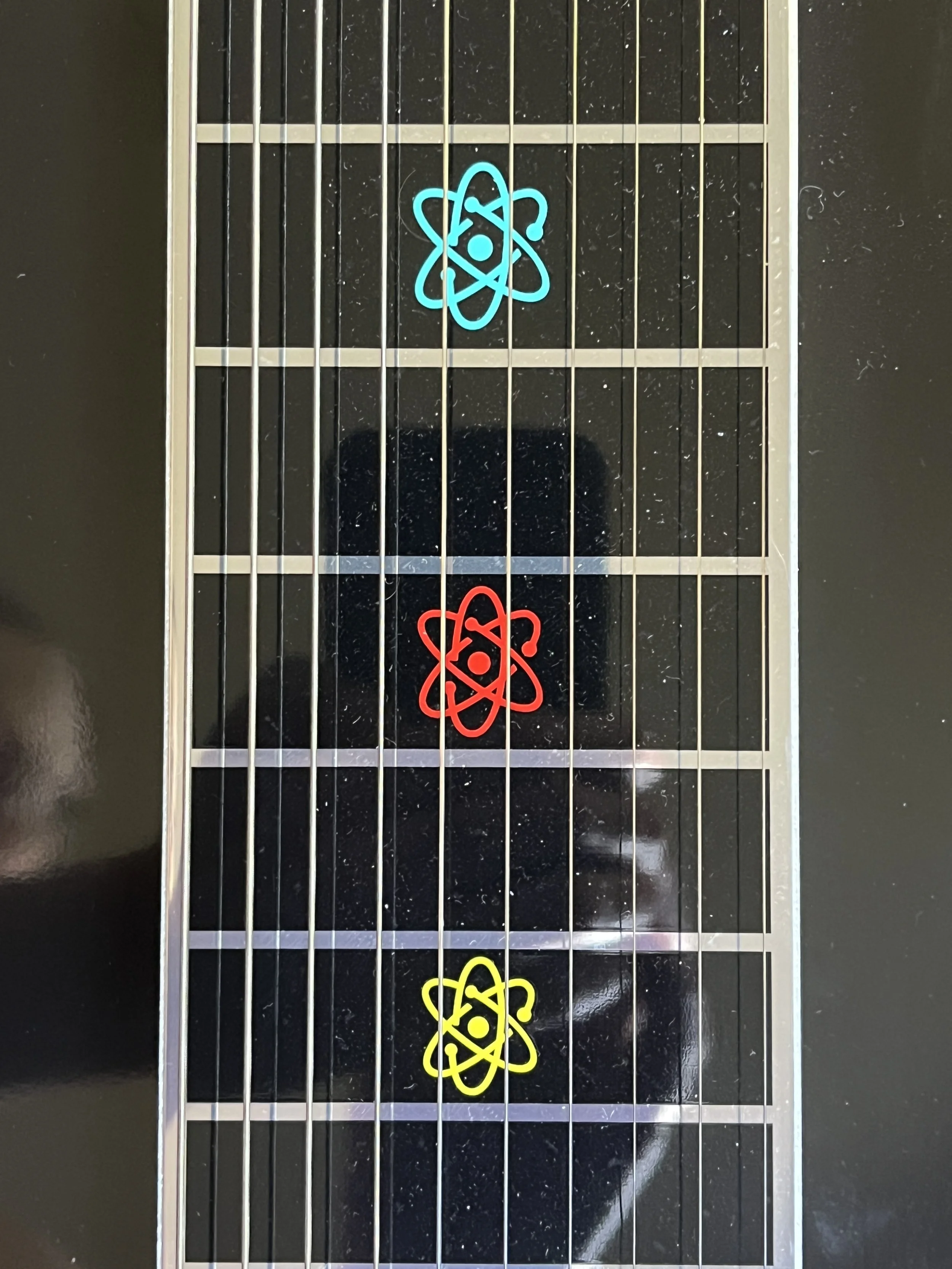 Emmons Resound'65 S10 Pedal Steel fret markers in retro atomic design in turquoise, red, yellow, and orange.