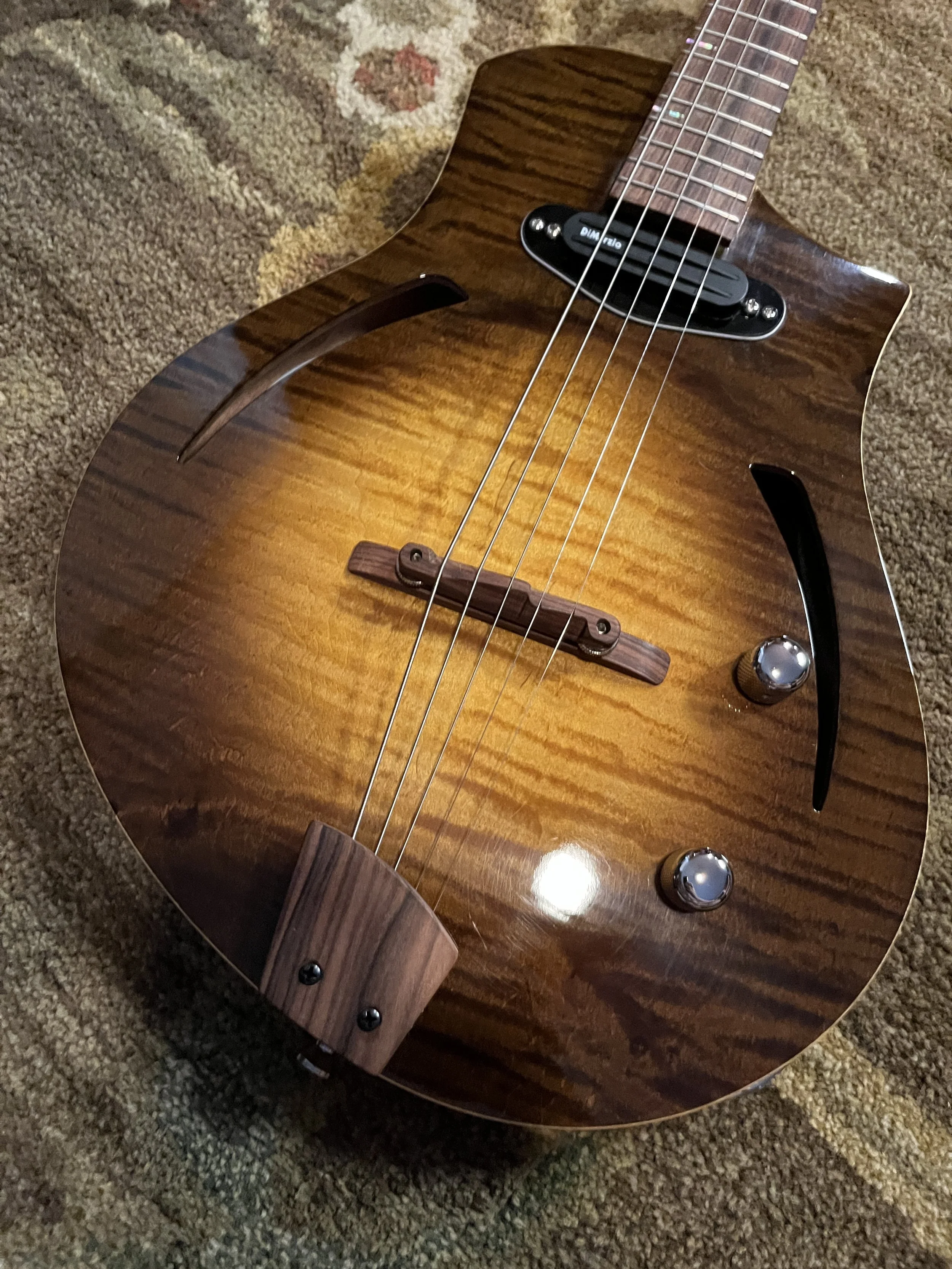 Mann Raven-Mandolin/Mandola detail of semihollow body's belly with tailpiece and bridge.
