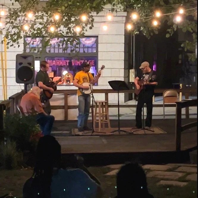 Luthier Michael Swanson (right) with Rob Fenter (center) and Jason Bailey (right) performing at The Irving Open Stage.