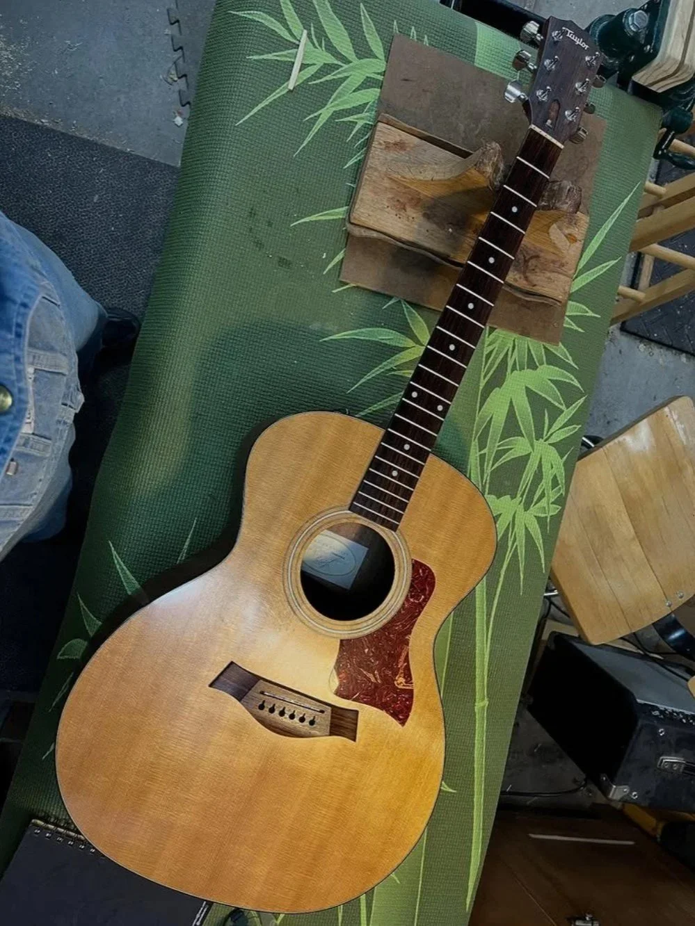 Taylor 114e acoustic guitar on the Two Moons Lutherie workbench after a setup.