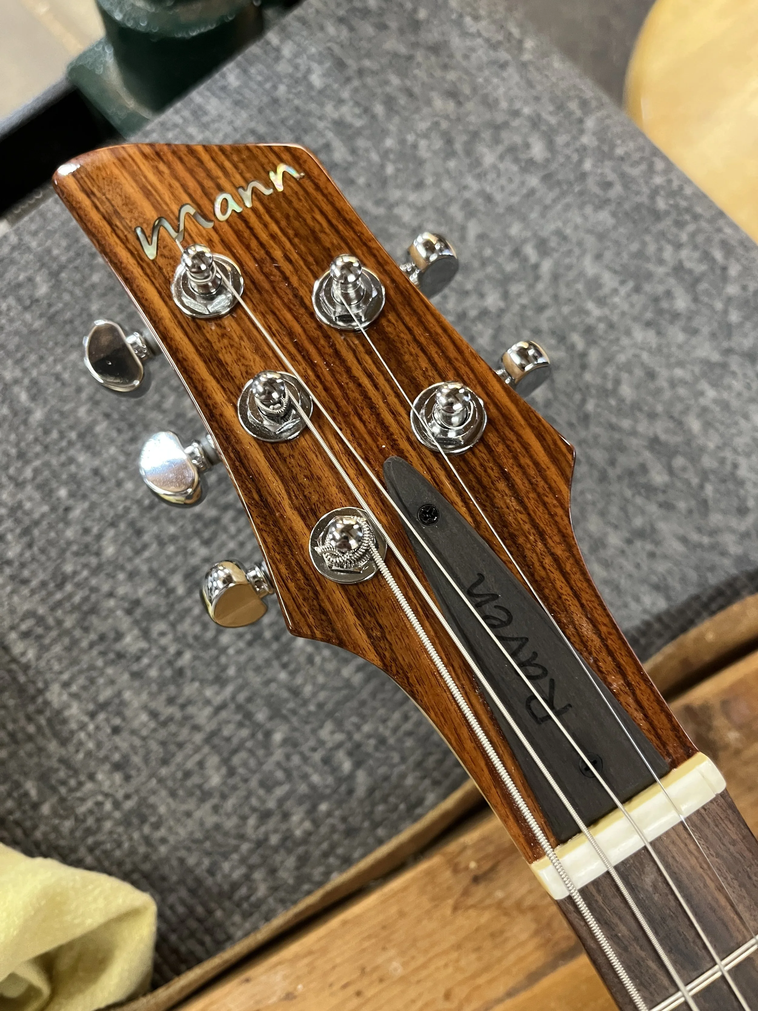 Mann Raven-Mandolin/Mandola front of headstock closeup, showing nut, tuners, and neck plate.