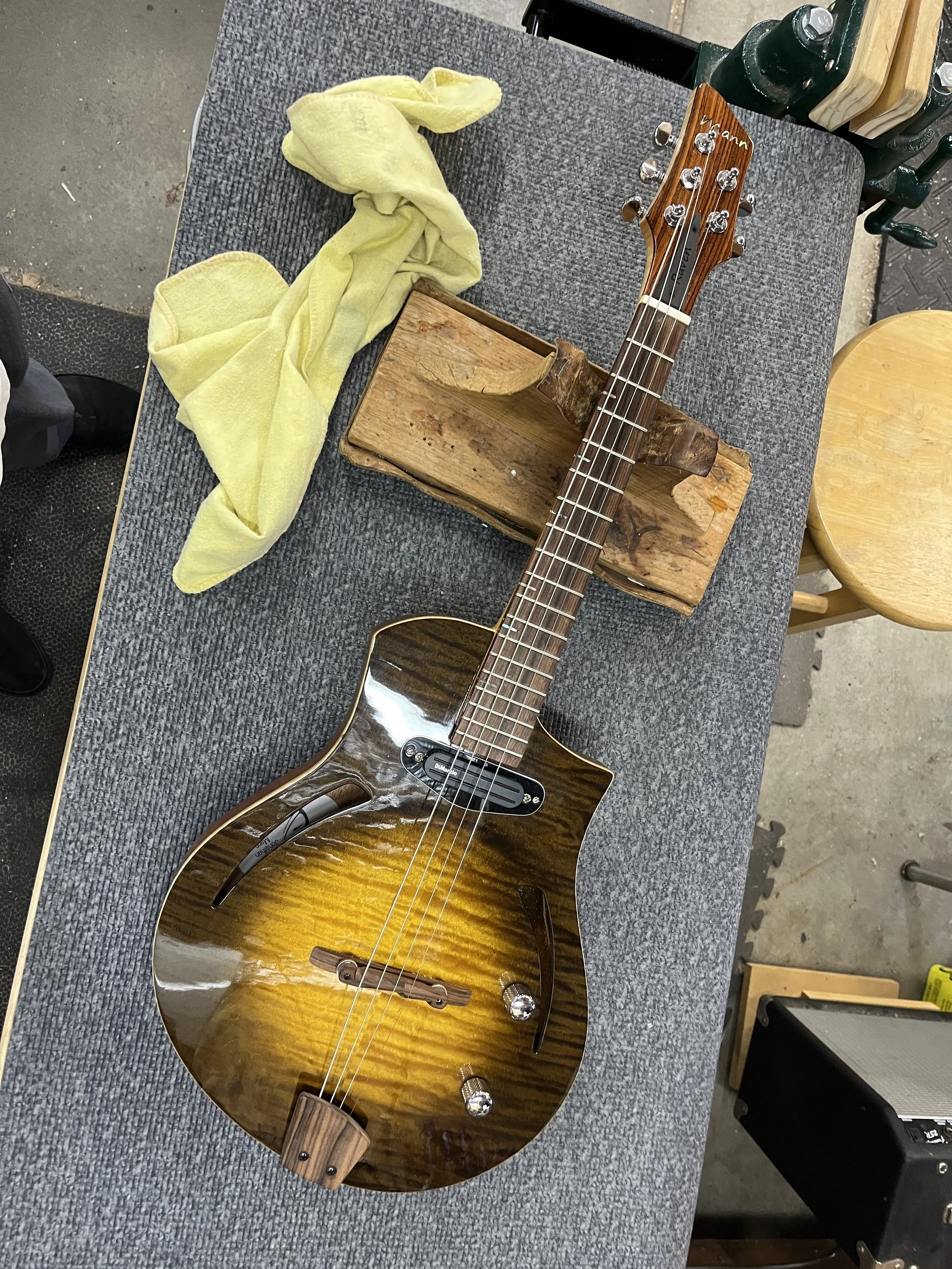 Mann Raven-Mandolin/Mandola lying on luthier's bench, front view.