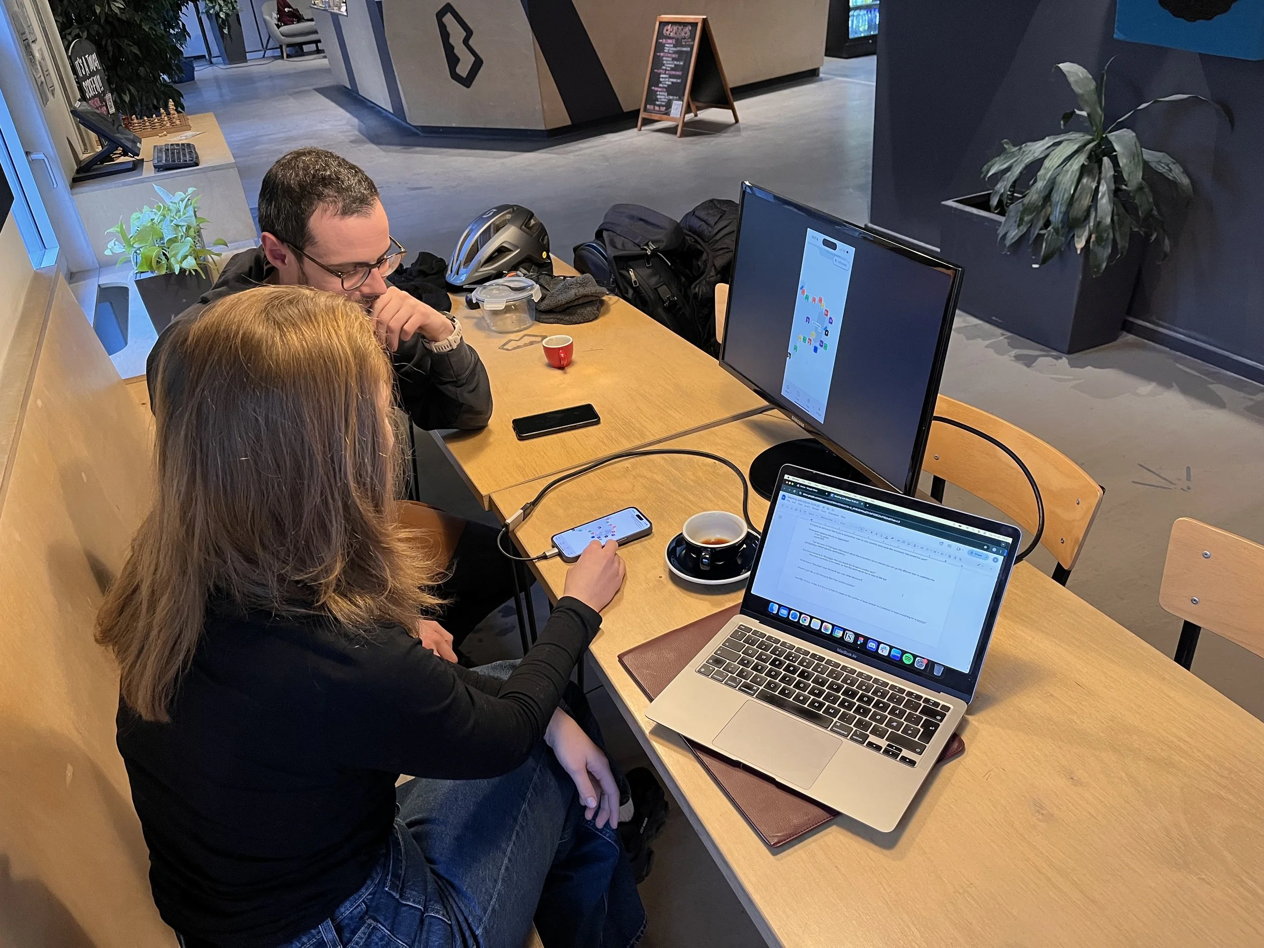 An image showing me interviewing and testing with a route setter at a climbing gym.