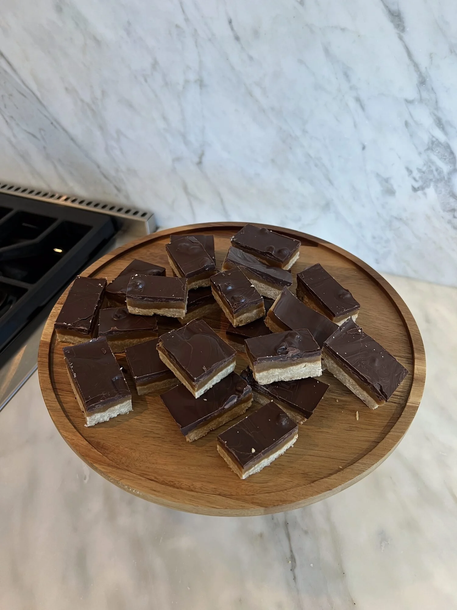 Refined-sugar-free peanut butter caramel bars on a serving board