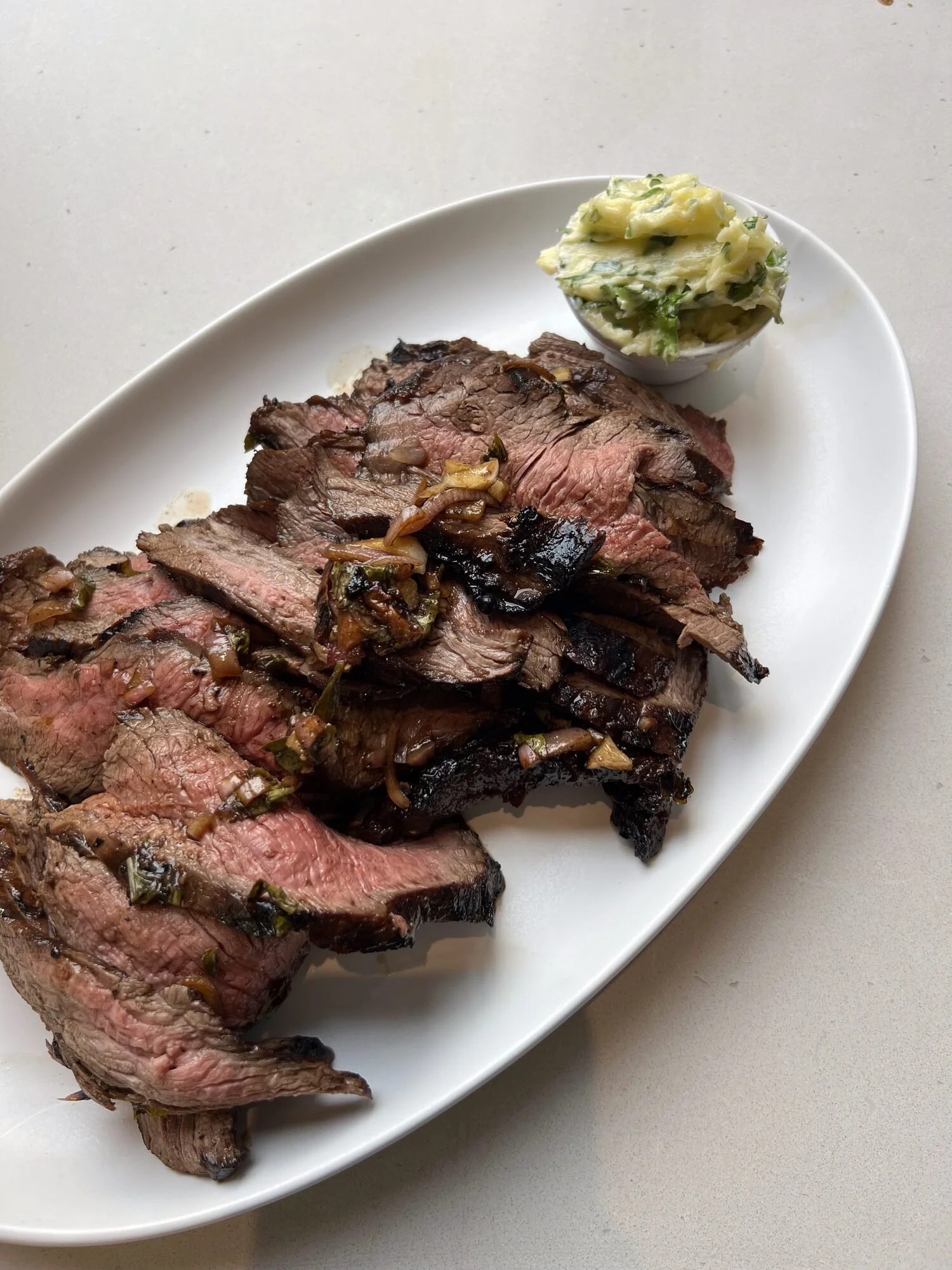 Grilled flank steak sliced on a platter