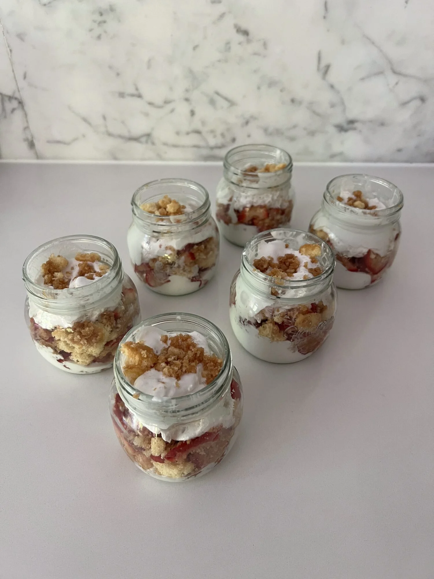 Layered yogurt parfait jars with fruit and granola for weekly meal prep