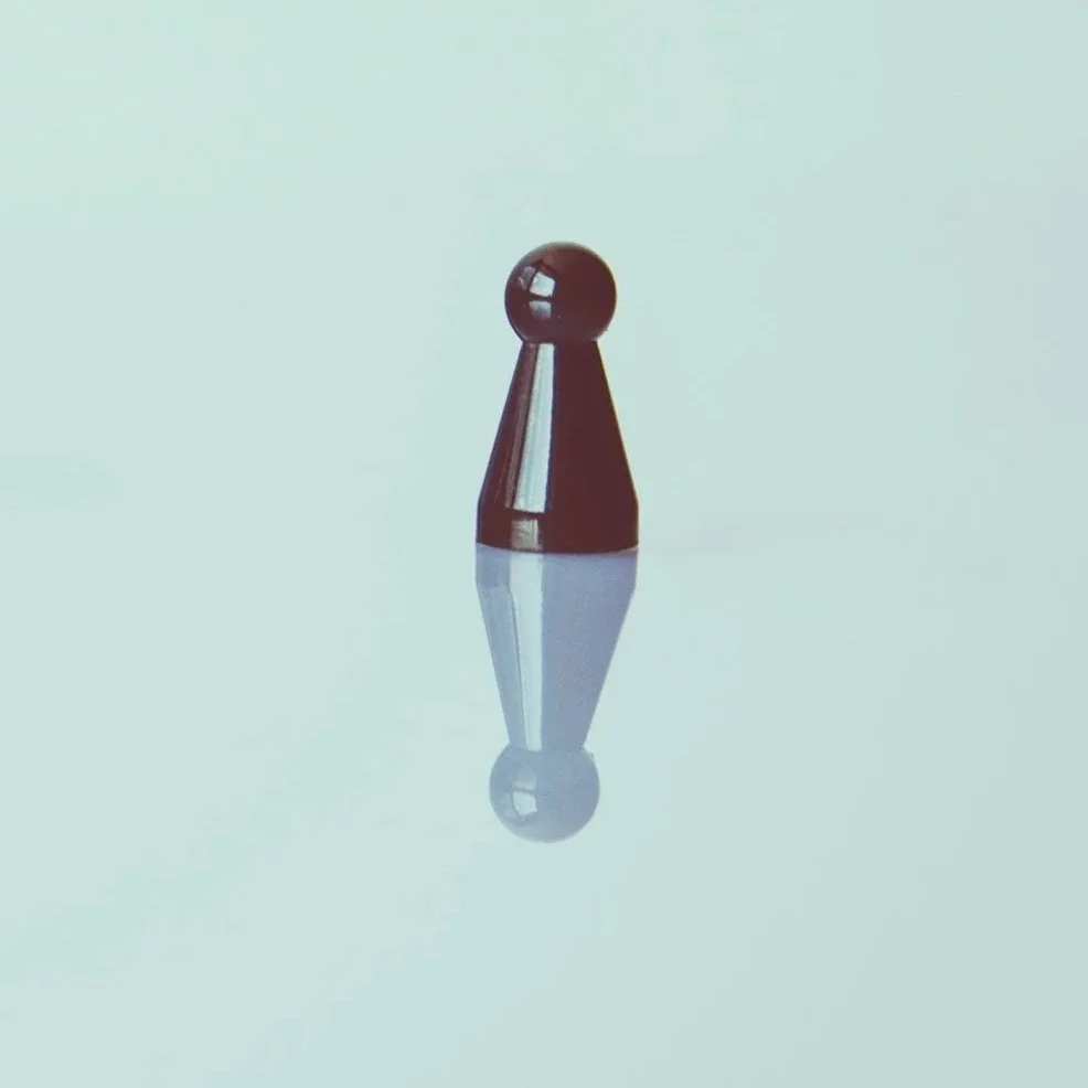 A single black pawn chess piece with its reflection on a smooth surface.