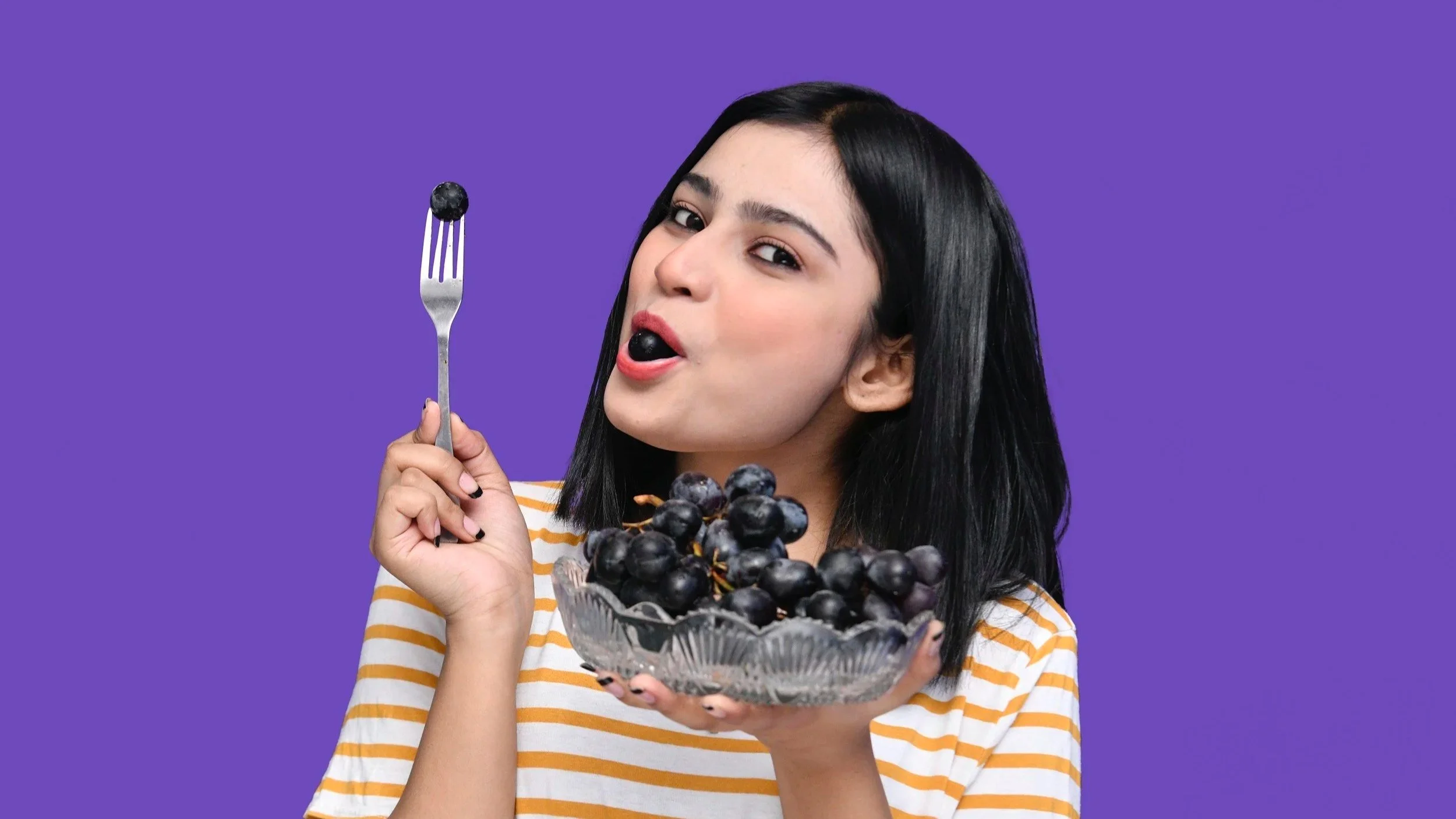 girl with brown hair eating grapes with a striped shirt Wellspring Therapy Associates Eating Disorder Signs and Recovery