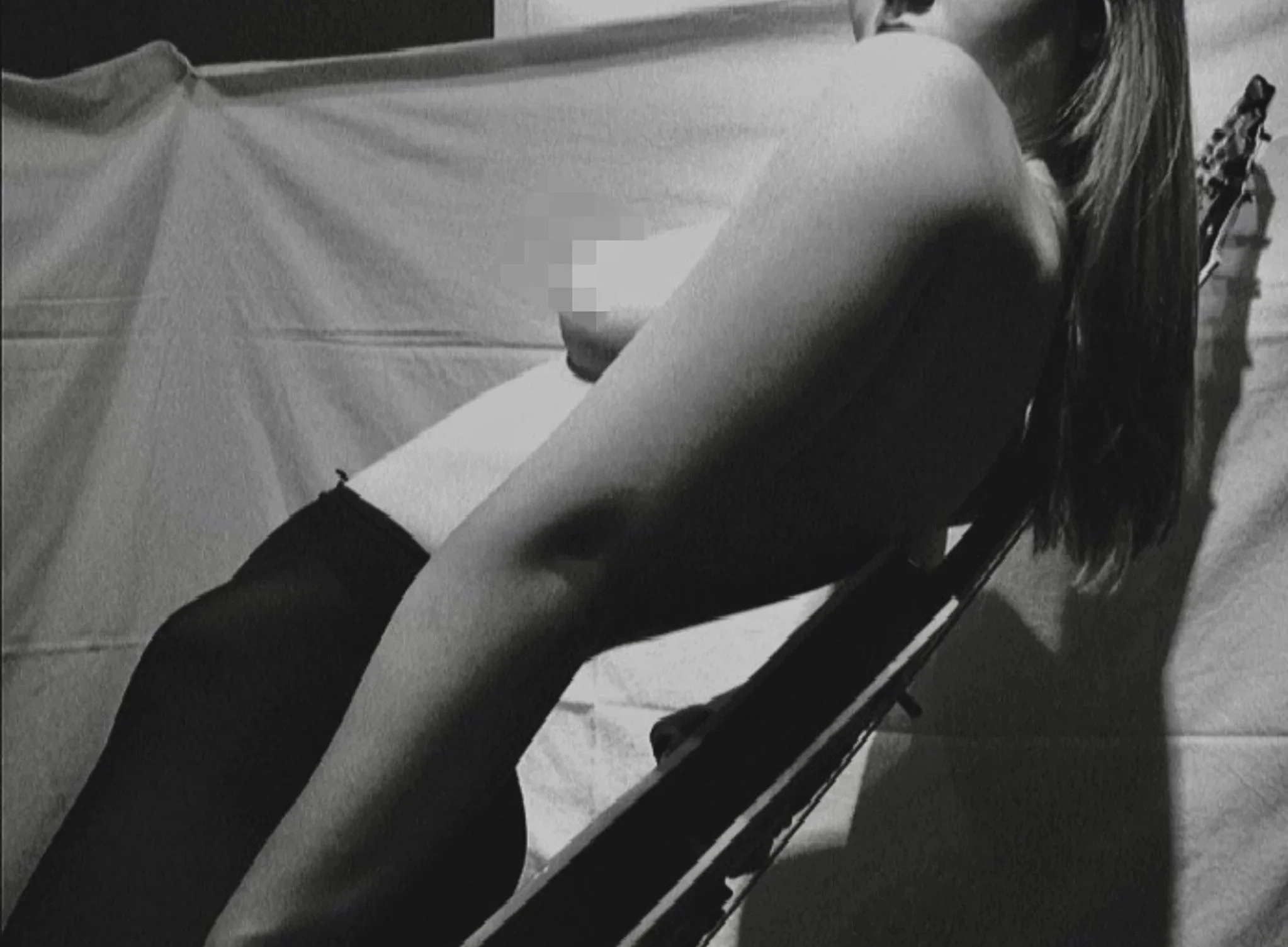 Black and white self-portrait study exploring gesture, light, and the relationship between body and space.