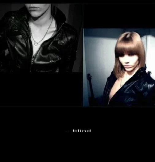 Black and white self-portrait showing a cropped view of a woman wearing a leather jacket, photographed indoors.