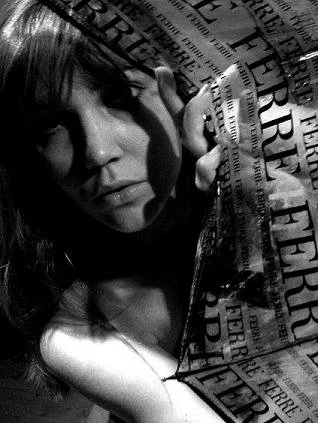 Self-portrait partially wrapped in printed, semi transparent umbrella, black and white