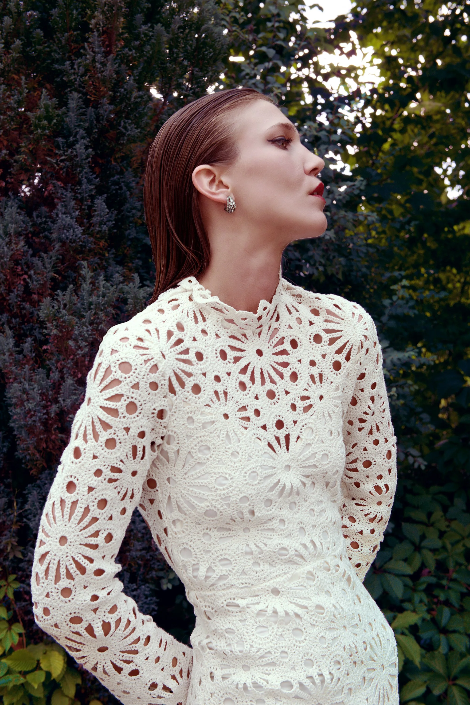 Color portrait of Lou Vicious wearing a lace dress, photographed outdoors during a collaborative photoshoot