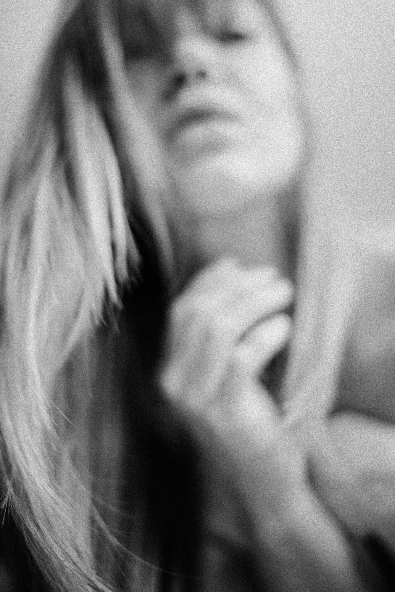 Highly abstract black-and-white portrait with blurred human form and indistinct features.