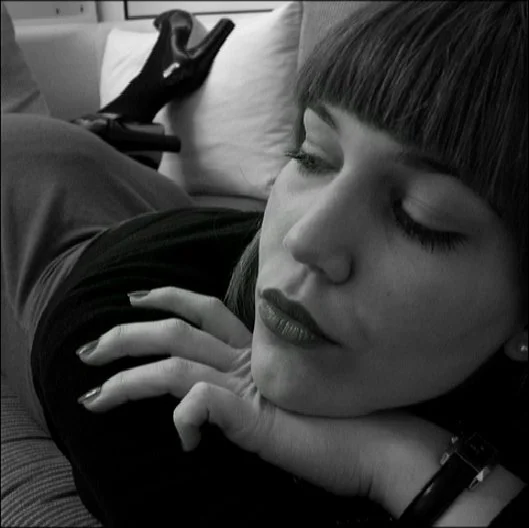 Intimate black-and-white portrait of a woman resting her head on her arm, quiet and contemplative