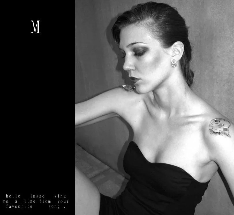 Black and white self-portrait of a woman in a strapless black dress, seated on the floor with her head turned to the side.