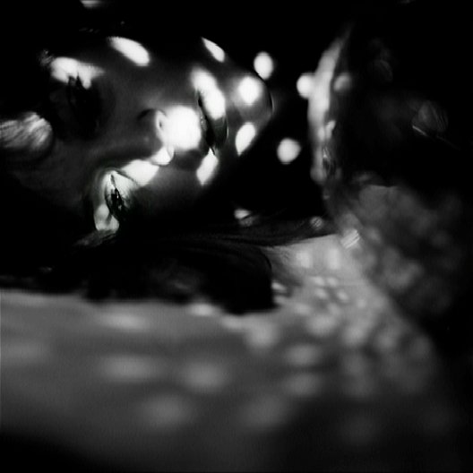 Abstract night self-portrait with blurred light and disco ball reflections, atmospheric and dreamlike