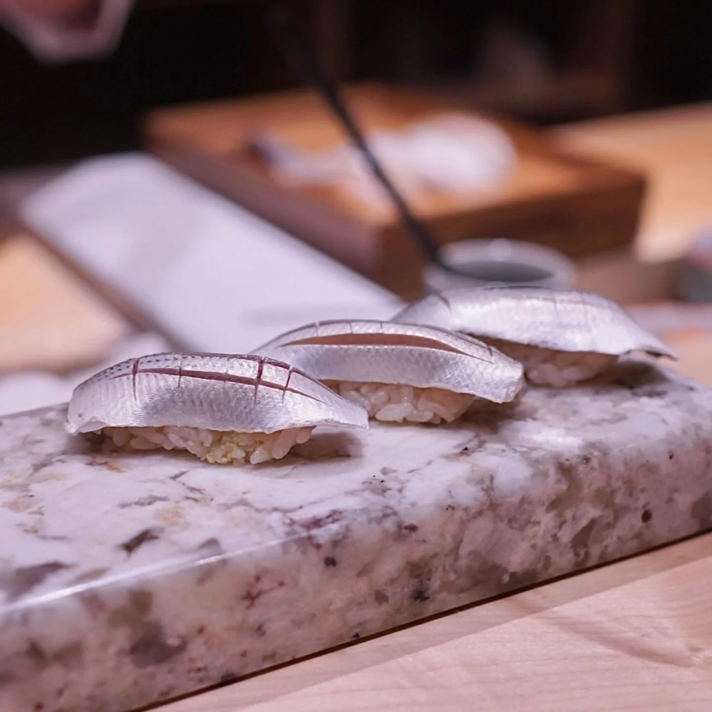 So nice and shiny! 😍 Fish with shimmering silver skin are called Hikarimono. Saba (mackerel), Aji (horse mackerel), Kohada (gizzard shad), Sayori (Japanese halfbeak), and Sardine are common types of Hikarimono. 

You can order this Saba nigiri in al