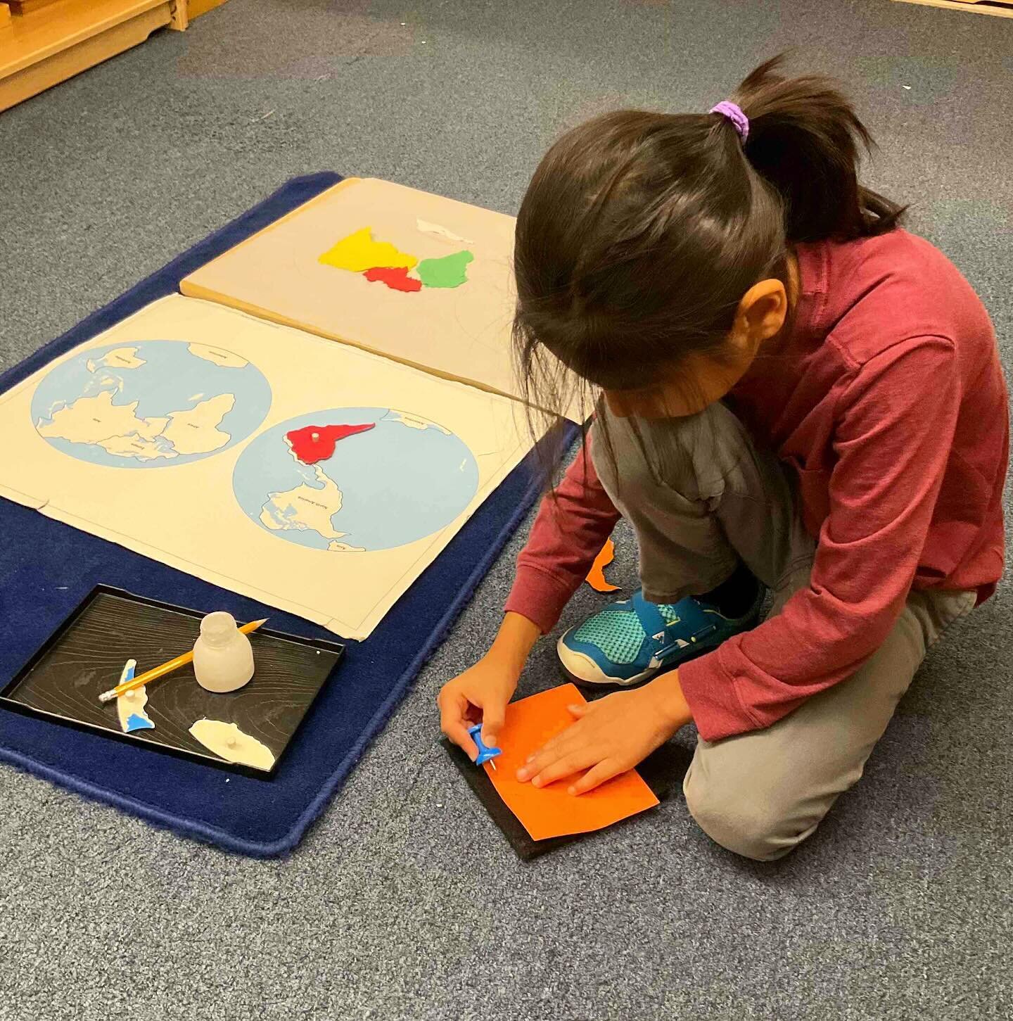 After transferring the puzzle pieces from the map to the control chart and learning the names of the continents, this child is making his own World Puzzle Map. This multi-step work tasks him with tracing the hemispheres onto the paper, then the conti