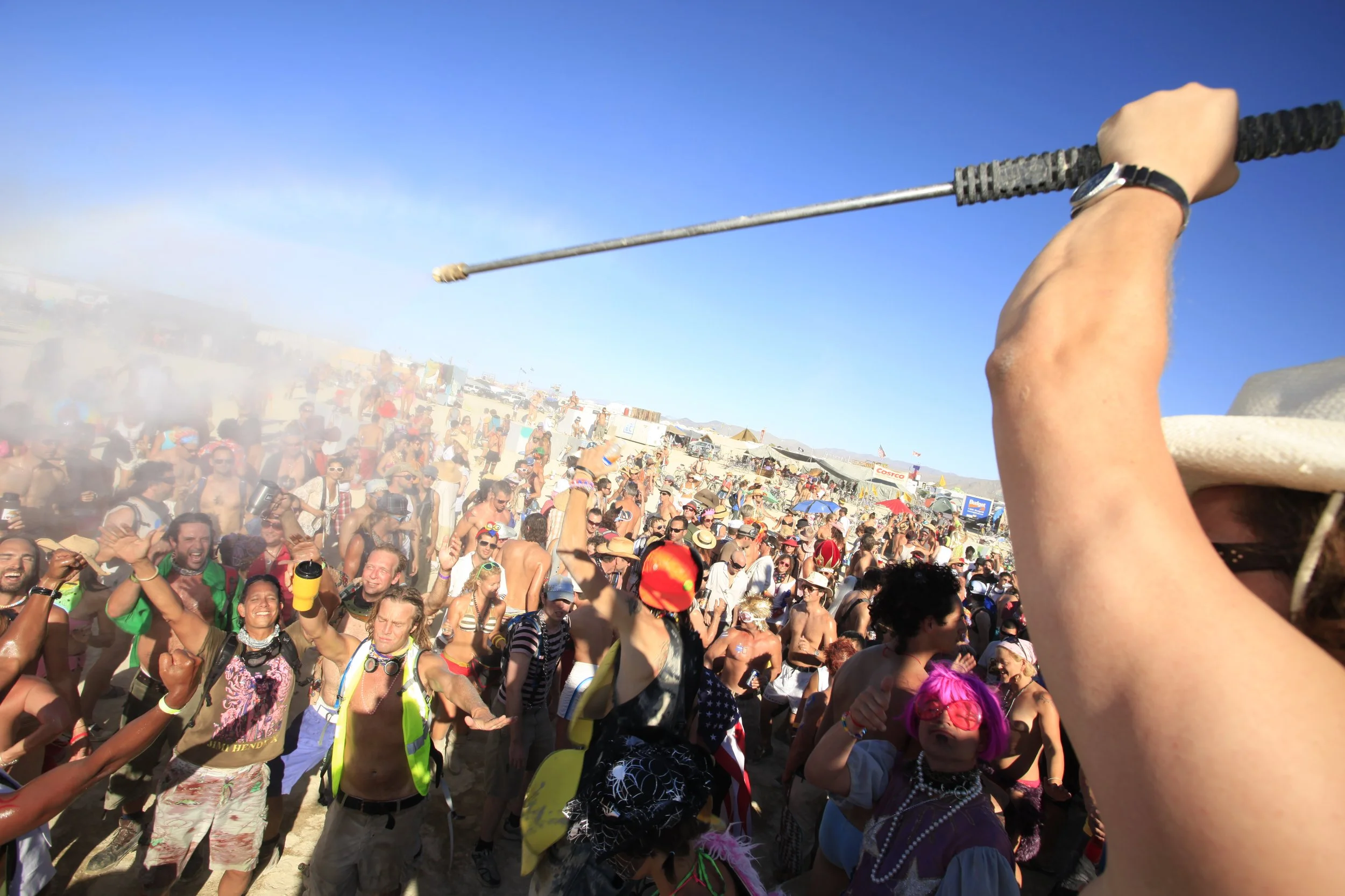 Burning Man 2010 290; Guy Spraying Distrikt With Water.JPG