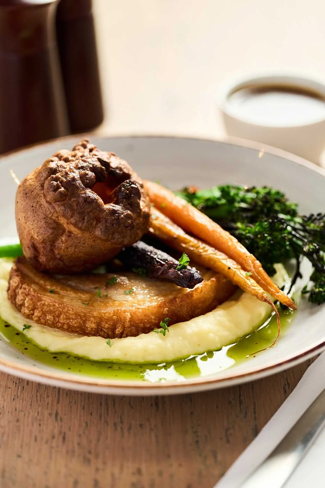 Roast Porchetta served on a bed of mash with broccolini