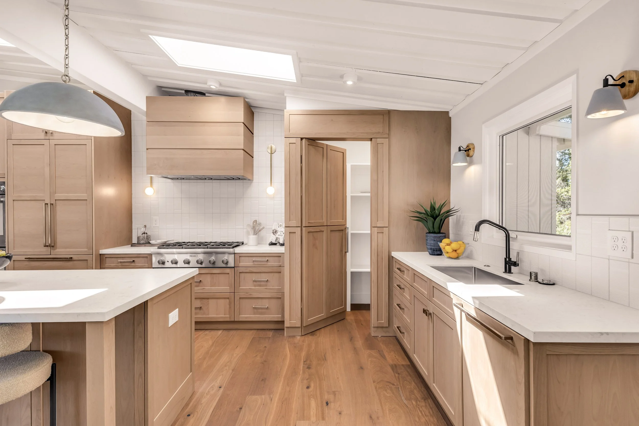 Hidden walk-in pantry with floor-to-ceiling custom cabinetry in an award-winning Orinda kitchen.