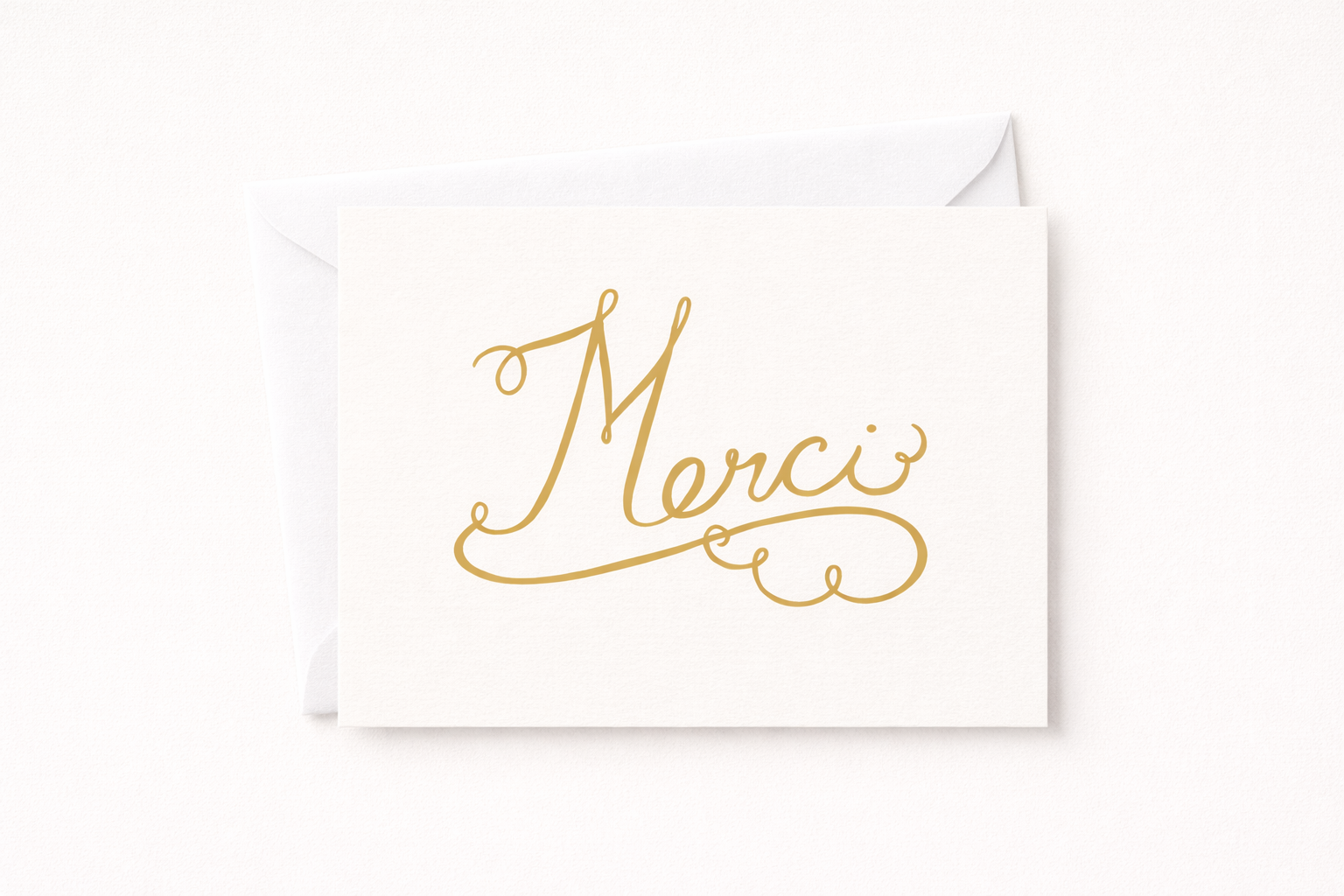 French Merci hand lettering on a warm white, minimalist thank you card
