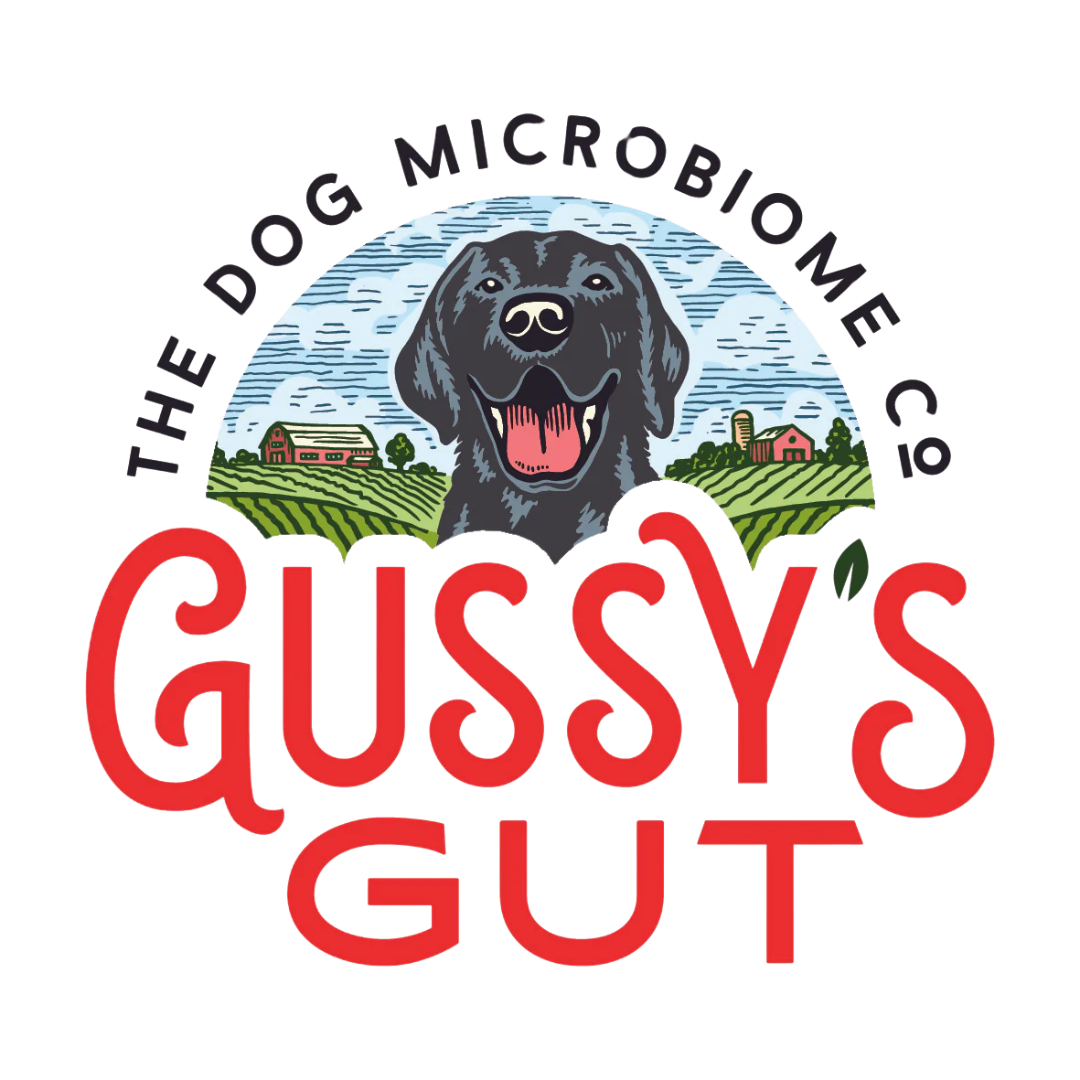 Logo featuring a black dog with its tongue out, again with a farm scene and sky in the background. The text around the logo reads "The Dog Microbiome Co." and the text in front reads "Guisy's Gut" in red.