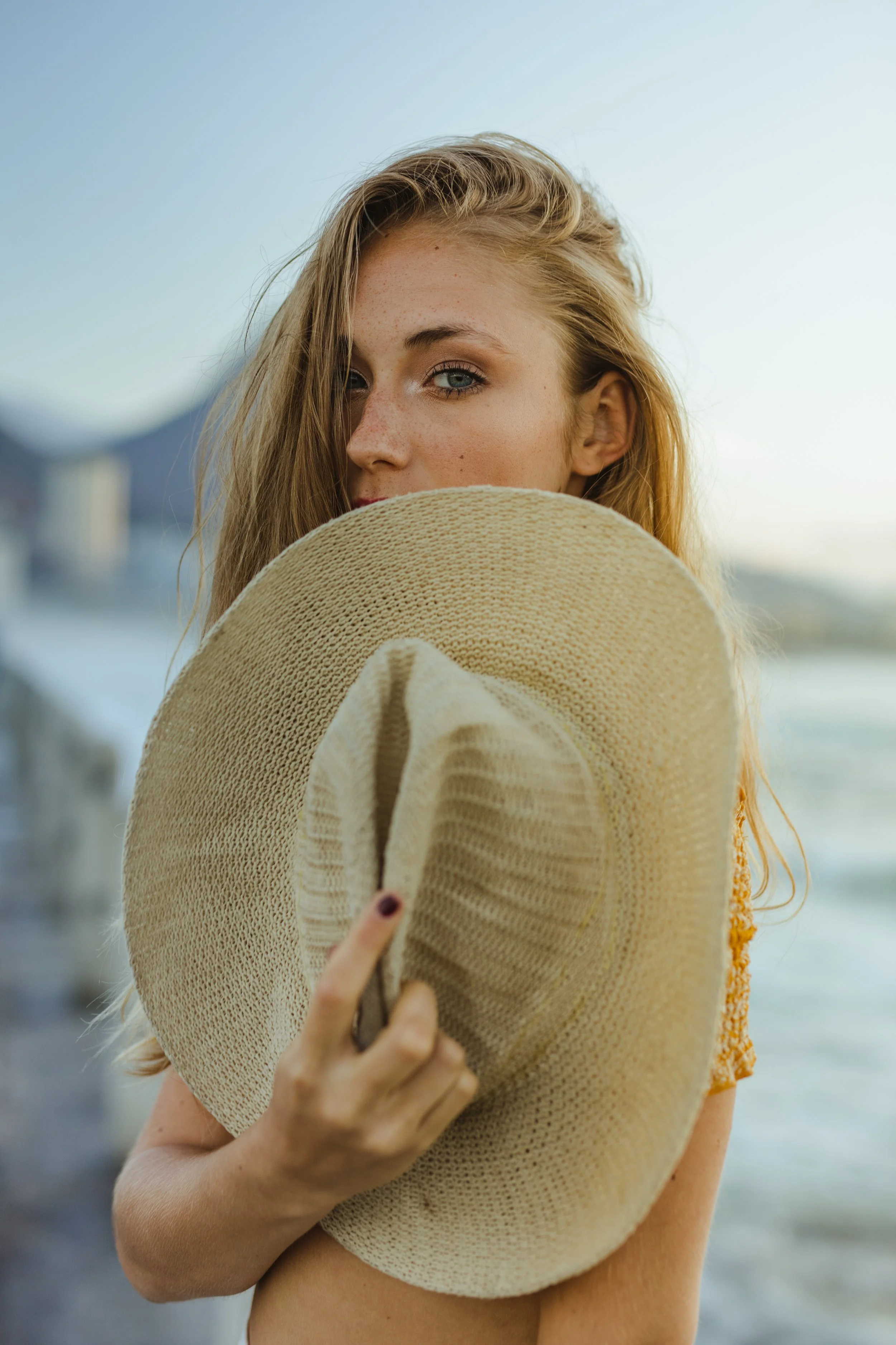 Lifestyle photography of blonde model with a hat in Cape Town, South Africa by photographer Vanartist