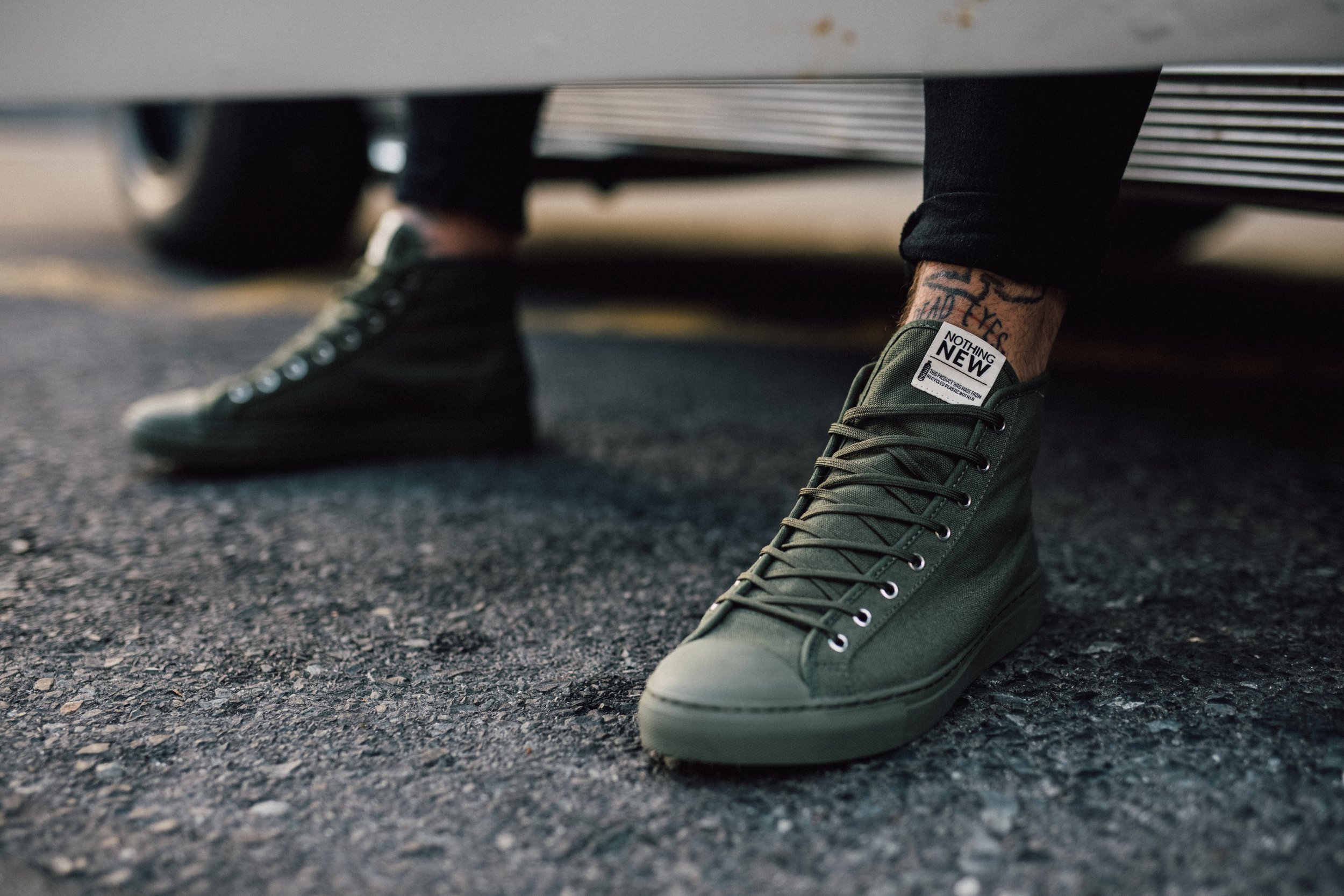 Fashion photography for Nothing New Footwear of a tattooed model sitting on a muscle car in Cape Town, South Africa by photographer Vanartist