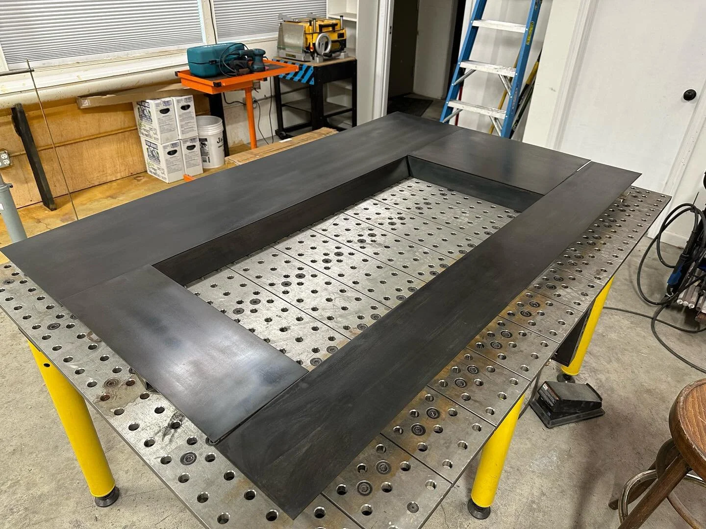 Fireplace wrap going on. This is a fun one that will match the guardrail oh-so nice.

#moderndesign
#metalfabrication
#TIGwelding
#handmade
#welding
#construction
#custommade 
#fireplace