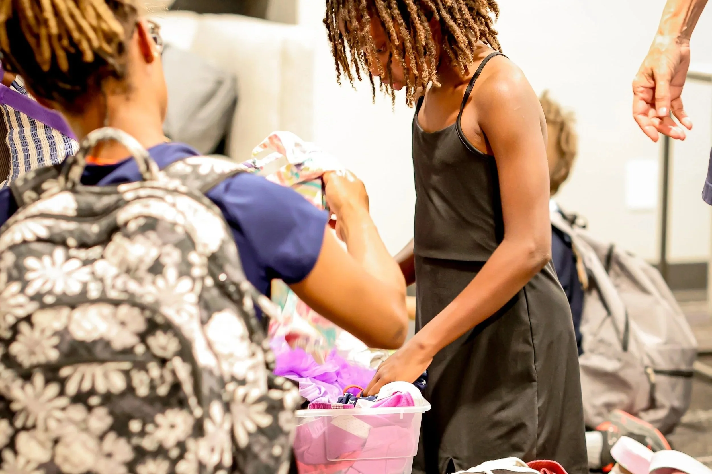 Volunteer sorting donated clothing at Joy Meadows foster care community clothing closet in Kansas City