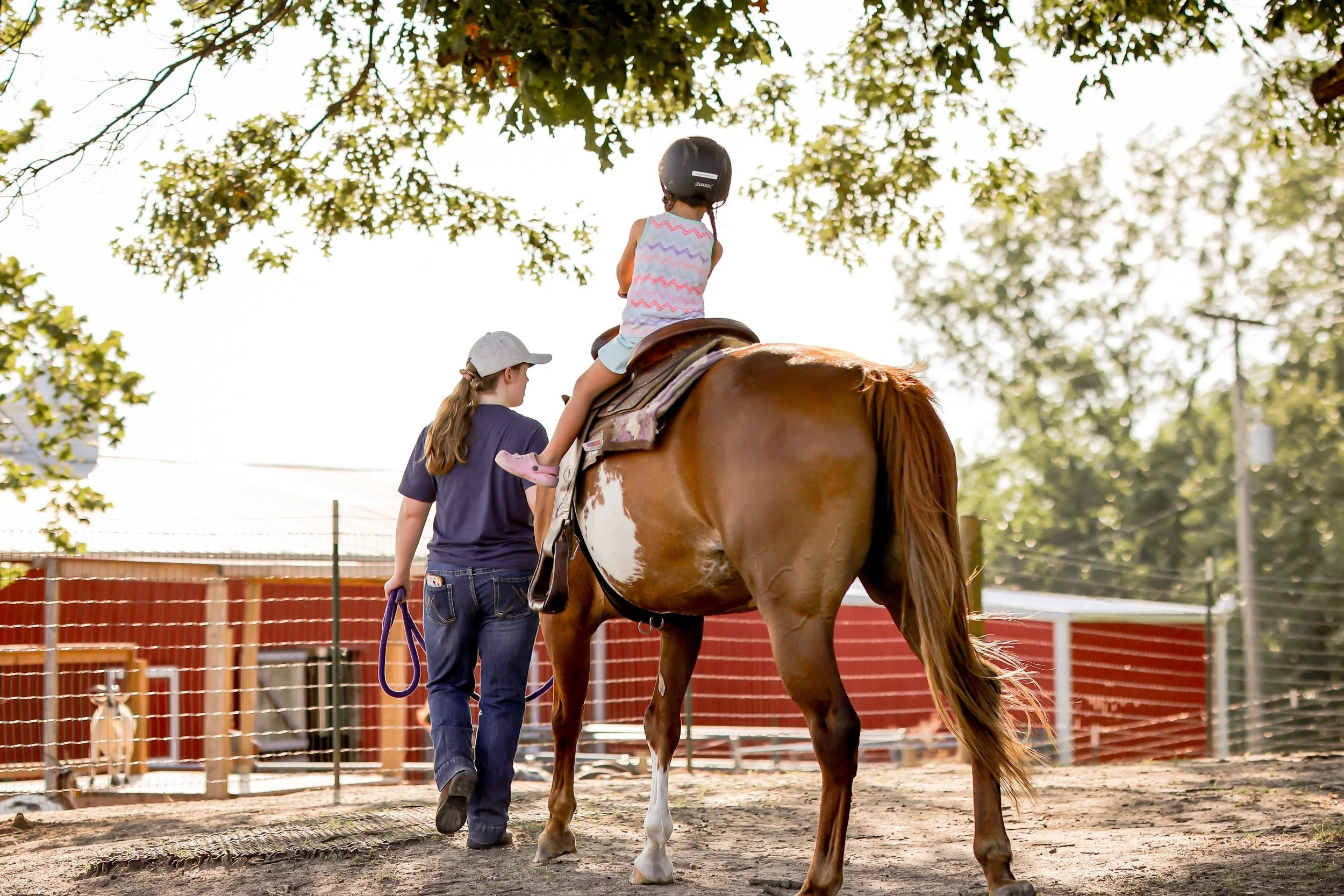 Child in foster care attending a horse riding lesson at Joy Meadow.