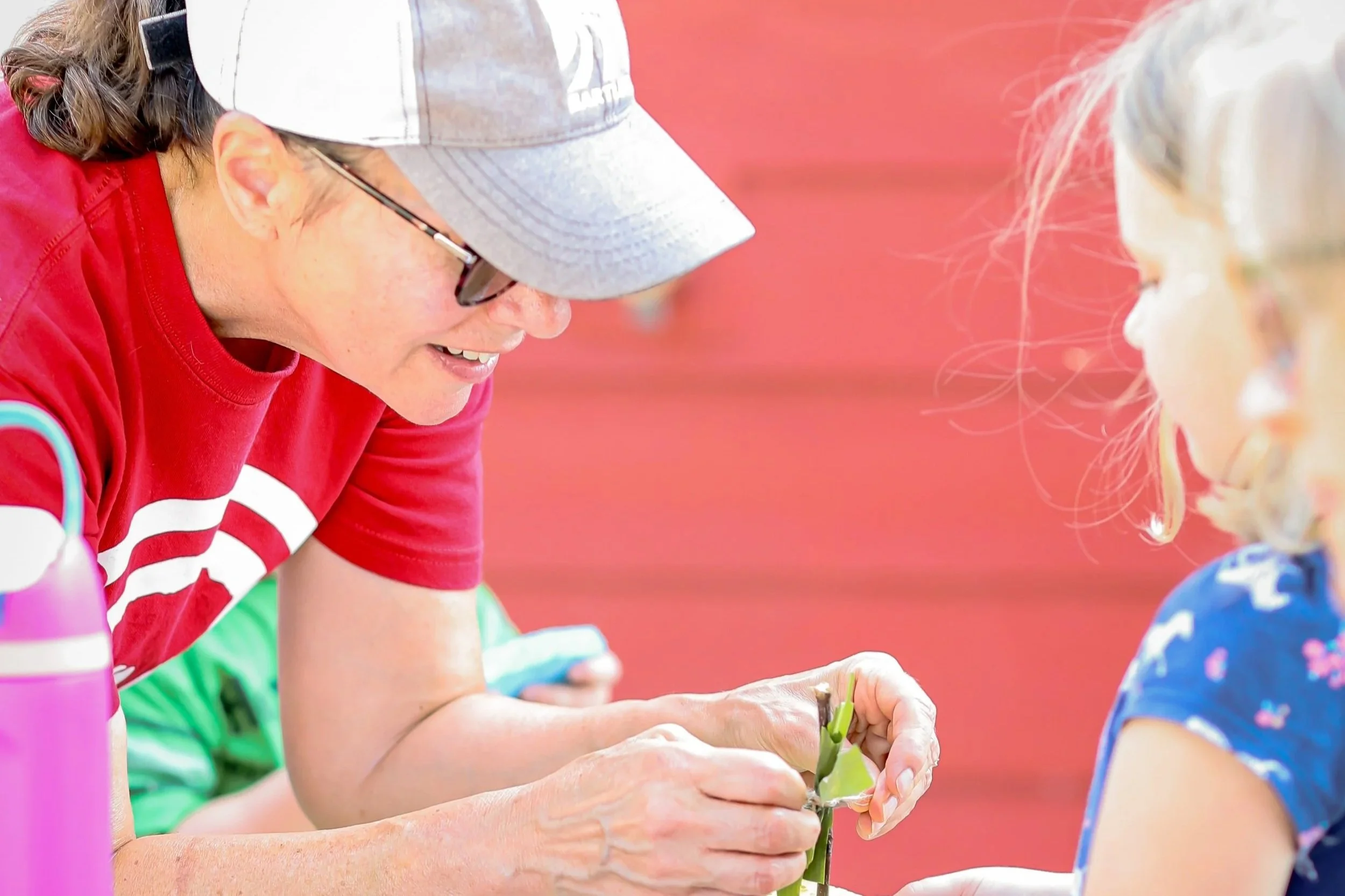 Adult encouraging a child in foster care with a high five at a Joy Meadows community event in Kansas City