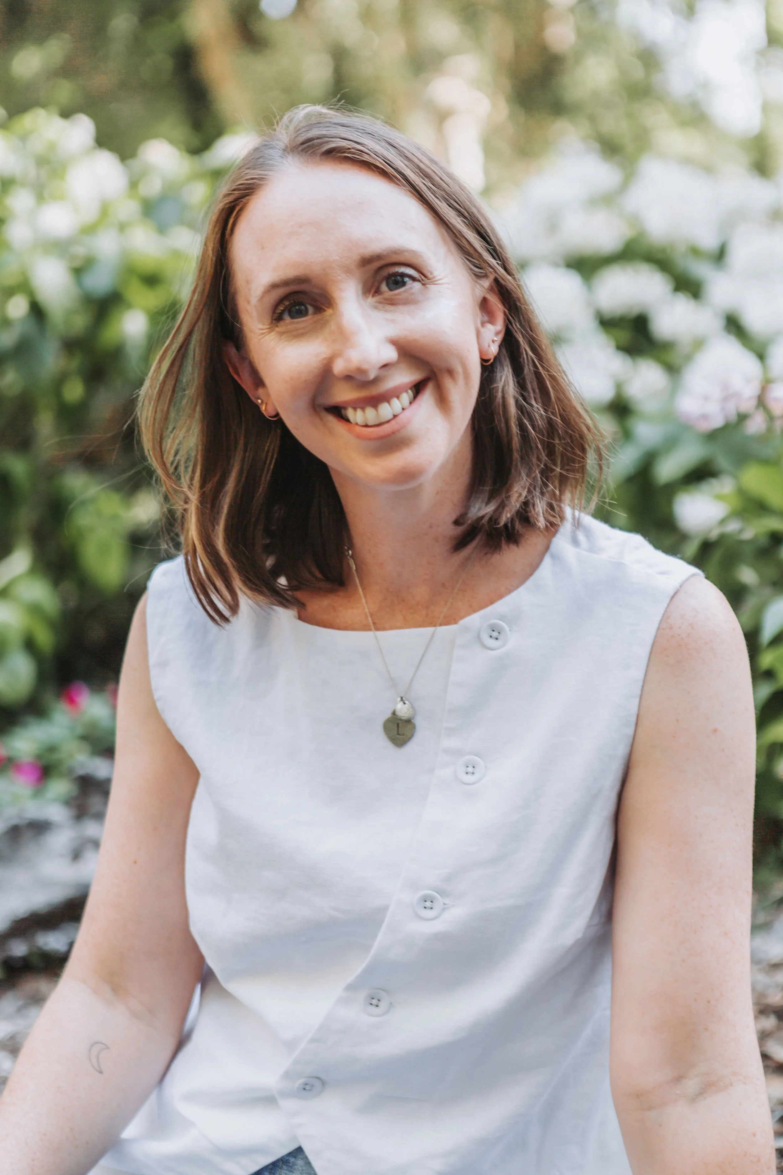Allie Shipman of Abbotts and Co Lawyers smiling at the camera at the Coffs Harbour Regional Botanic Garden