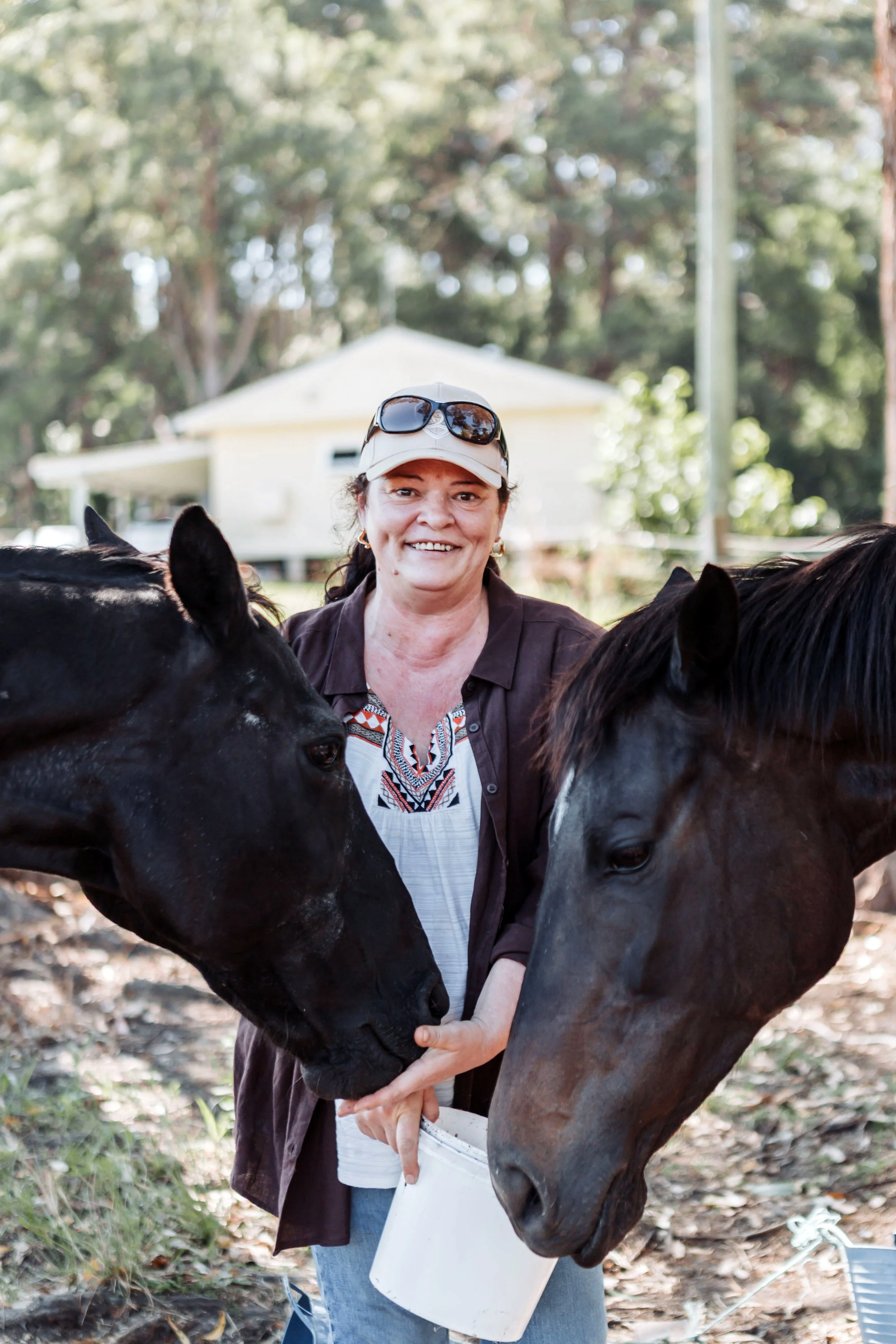 Law Graduate Belinda Mash with her two horses on a farm