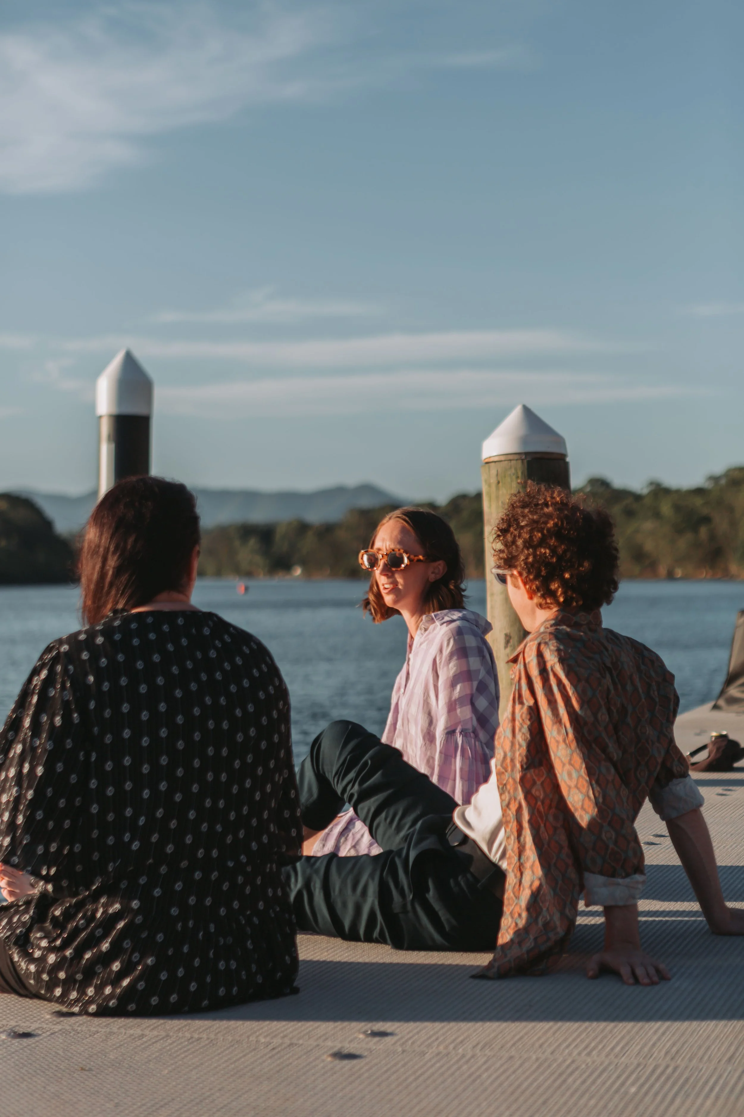 Team members from Abbotts and Co Lawyers relaxing on a Mid North Coast jetty at sunset