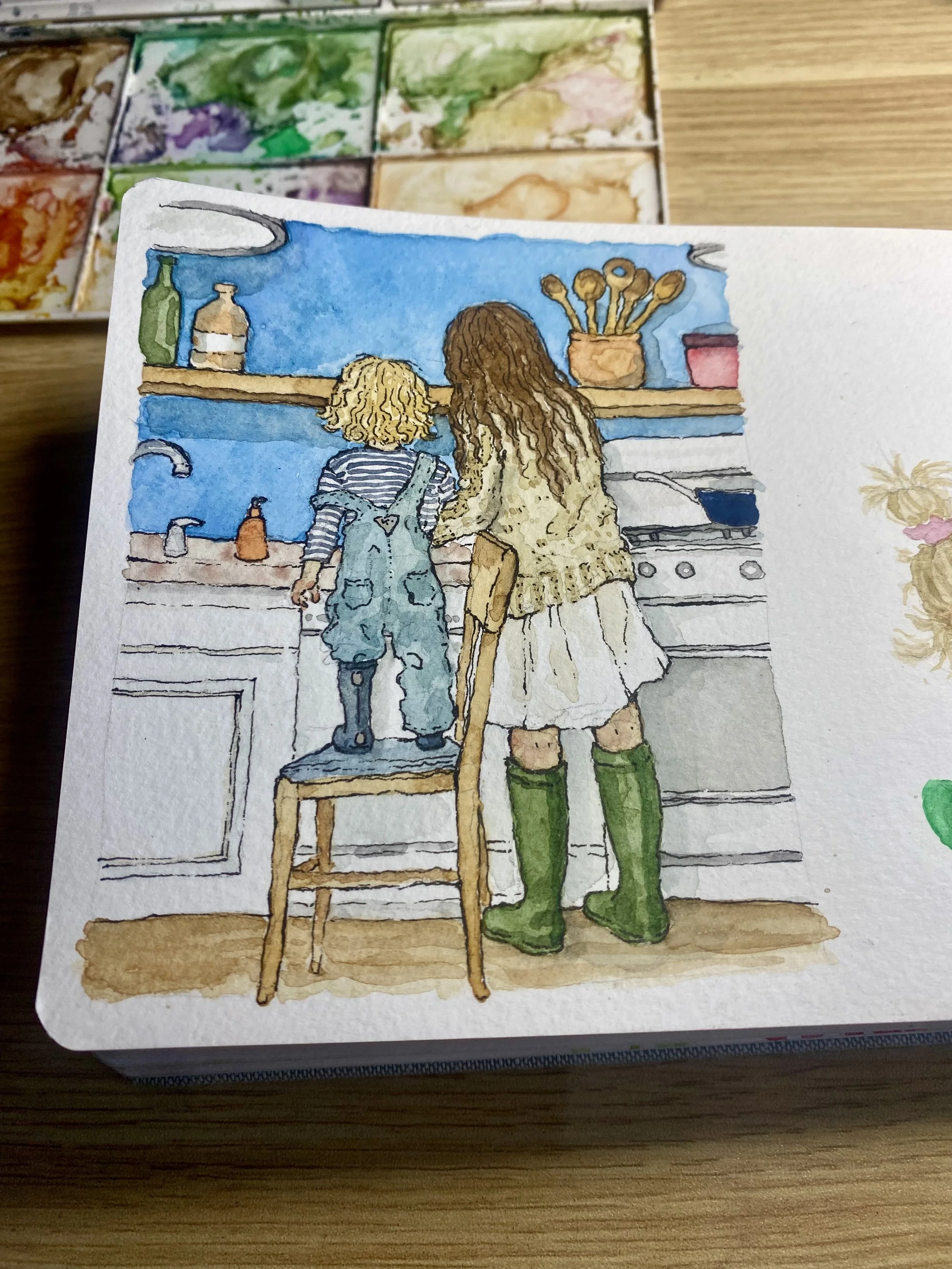 Watercolor painting of a woman and a young child standing in a kitchen, looking at a green and purple watercolor palette on a shelf.