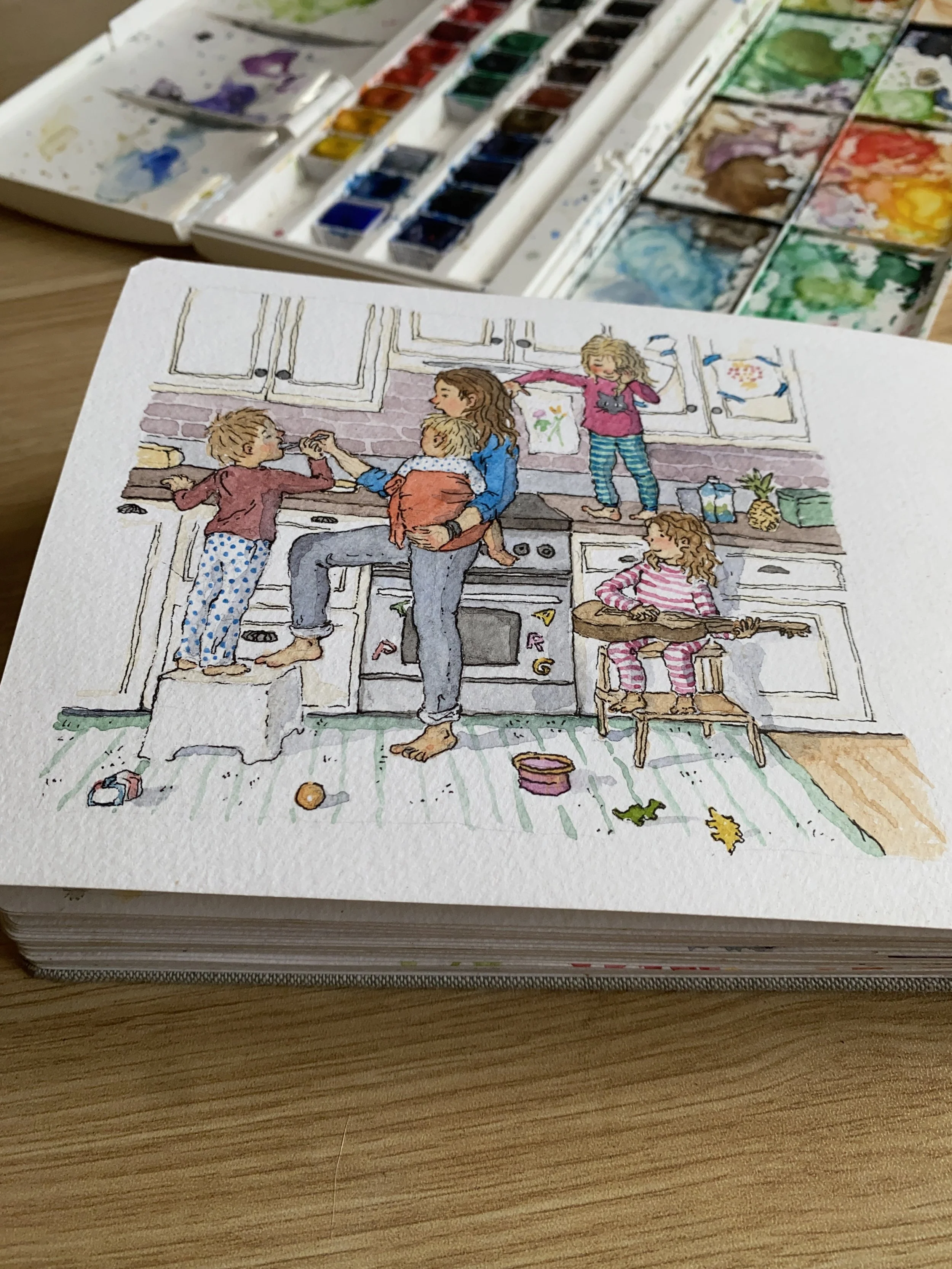 A watercolor illustration of a lively family scene in a kitchen with four children and a woman. The woman is holding a small child, and another child is standing on a stool handing her a puffed snack. Two other children are on the counter and chair, one playing a guitar, and the other reaching out to the woman. The kitchen has white cabinets, a stove, and various colorful drawings and food items on the counter and walls. Toys and snacks are scattered on the floor.