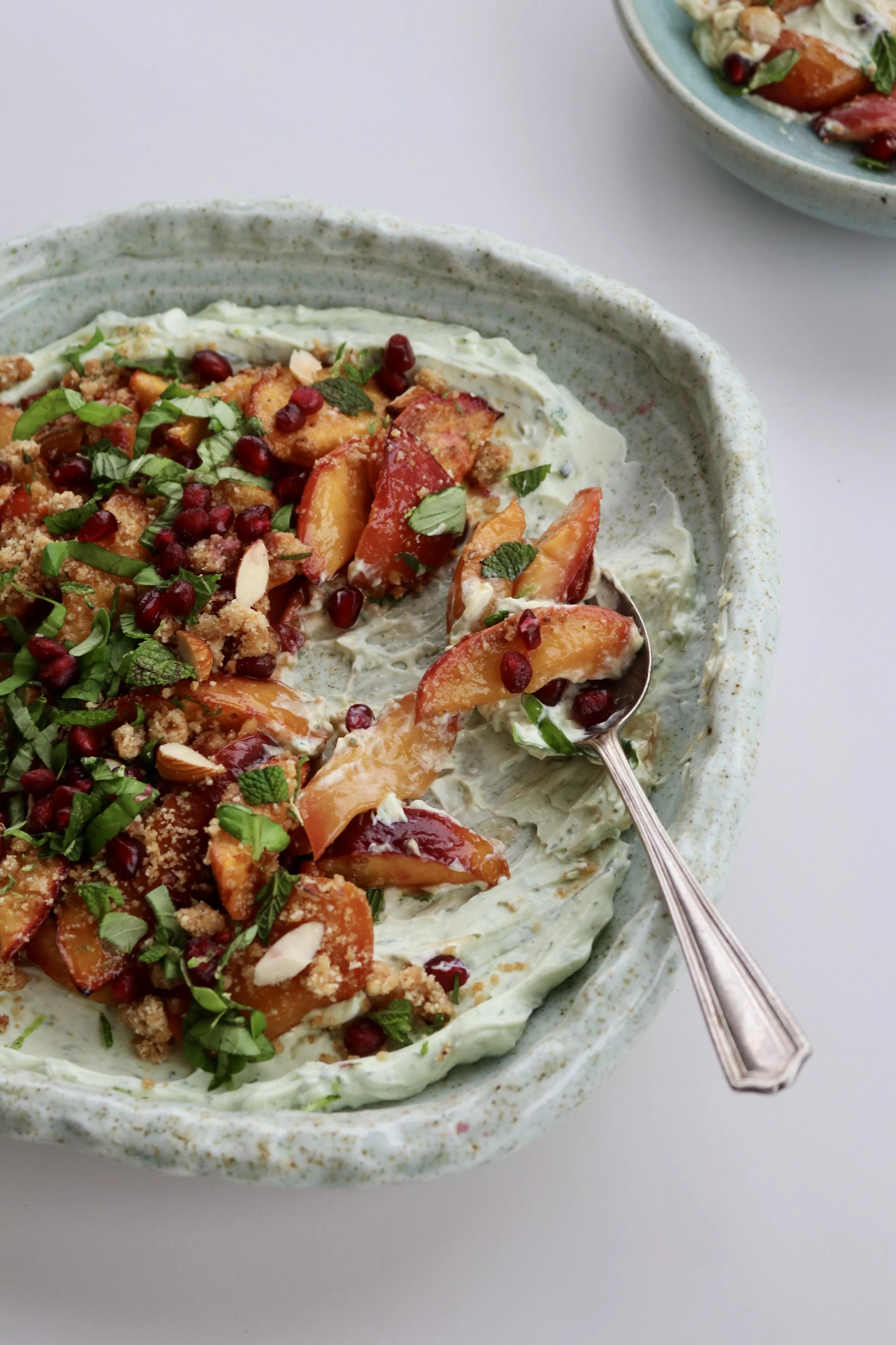 Roasted nectarines with green labneh, pomegranate and miso-almond crumb