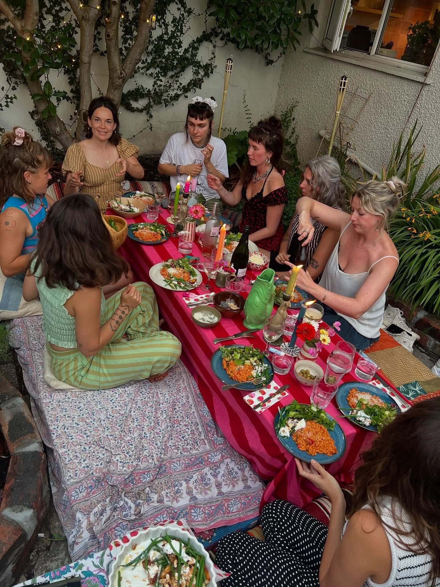 Ode to pink and red 🩷❤️ dinner in the garden with my fave gals wearing my Peggy trousers in Refreshers stripe, Seren jumpsuit in hibiscus, my cute cat, holiday jeans in Candy stripe, flowers, sunset check set, tomato heaven, flowers for my beautiful
