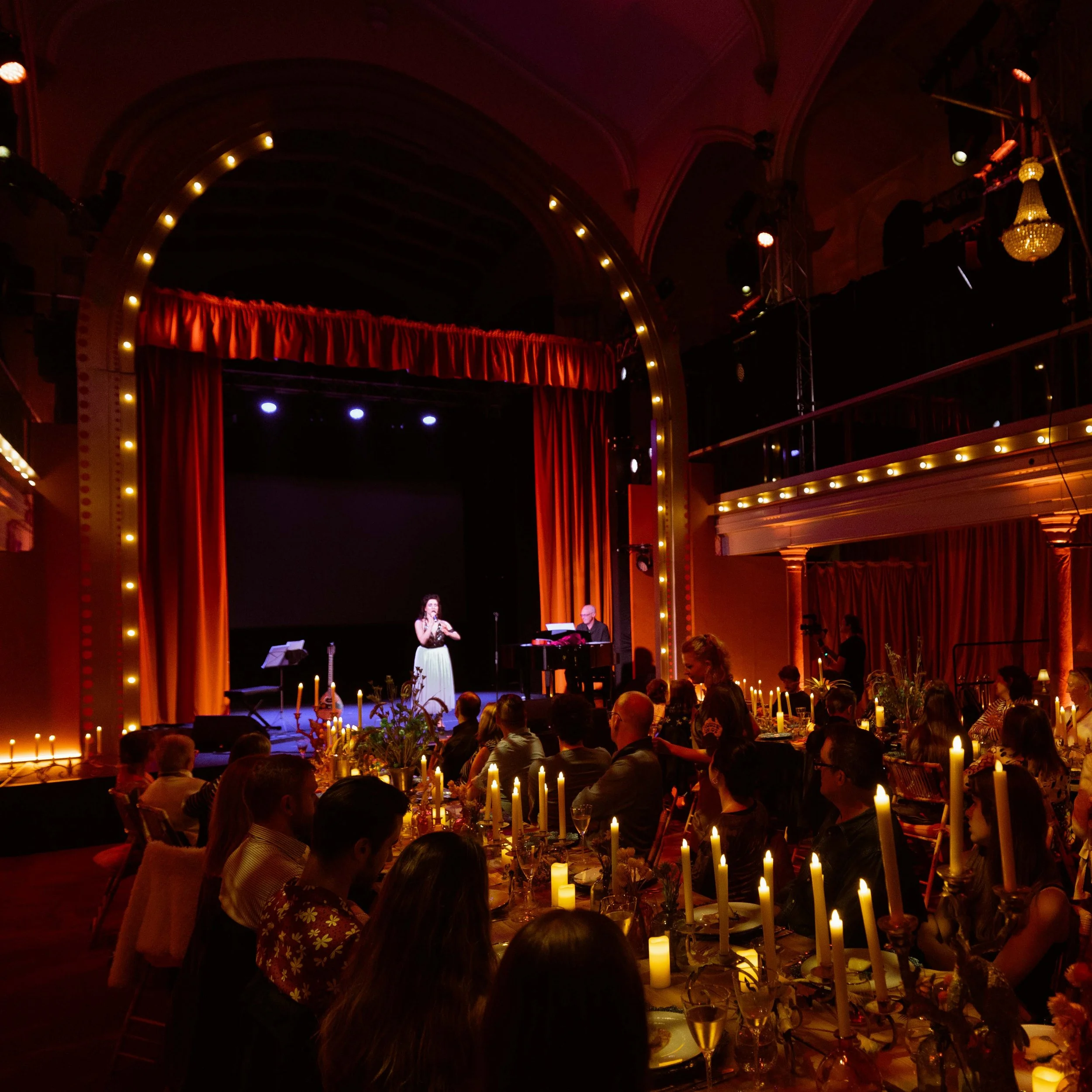 Michaela Burger performed A Migrant's Son at House of Oz 2023. This shot is from the previous year, when she presented excerpts at an evening of performance, storytelling and gastronomy entitled Taste of Australia, in 2022.