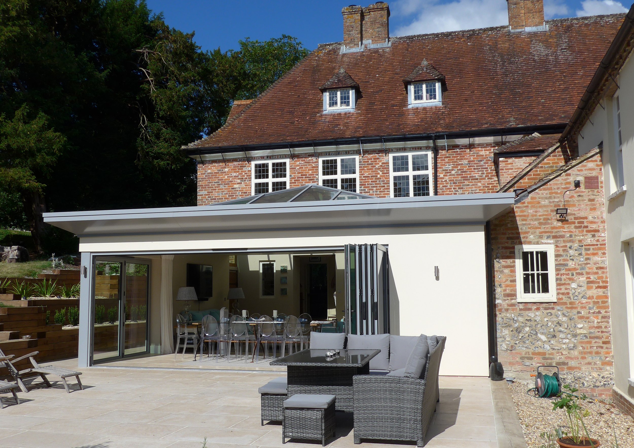 New Garden Room to former rectory made with utilising steelwork and adopting a contemporary approach in order to keep the structure lean as to not obscure views from first floor window.