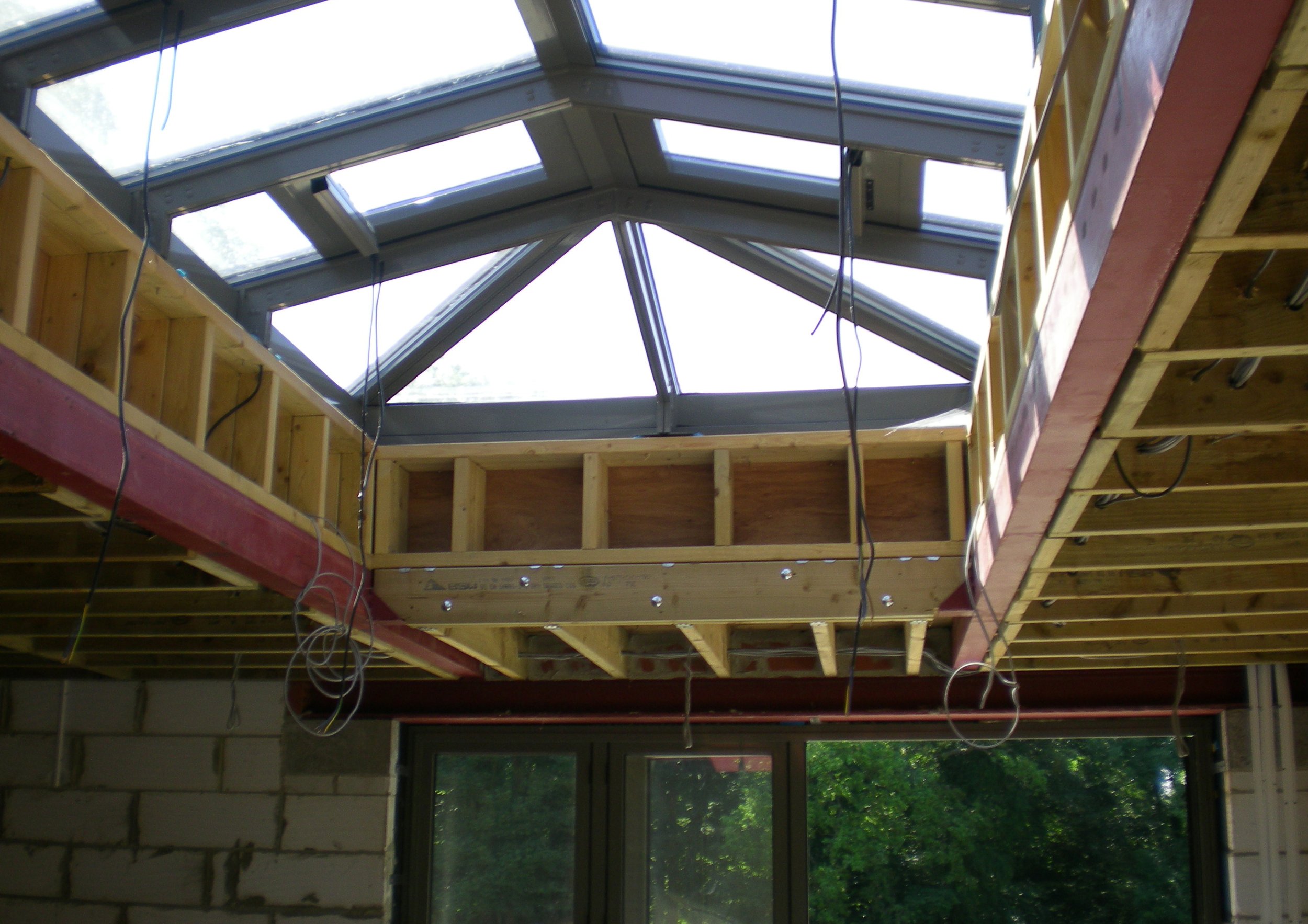 In construction skylight showcasing exposed rafters.