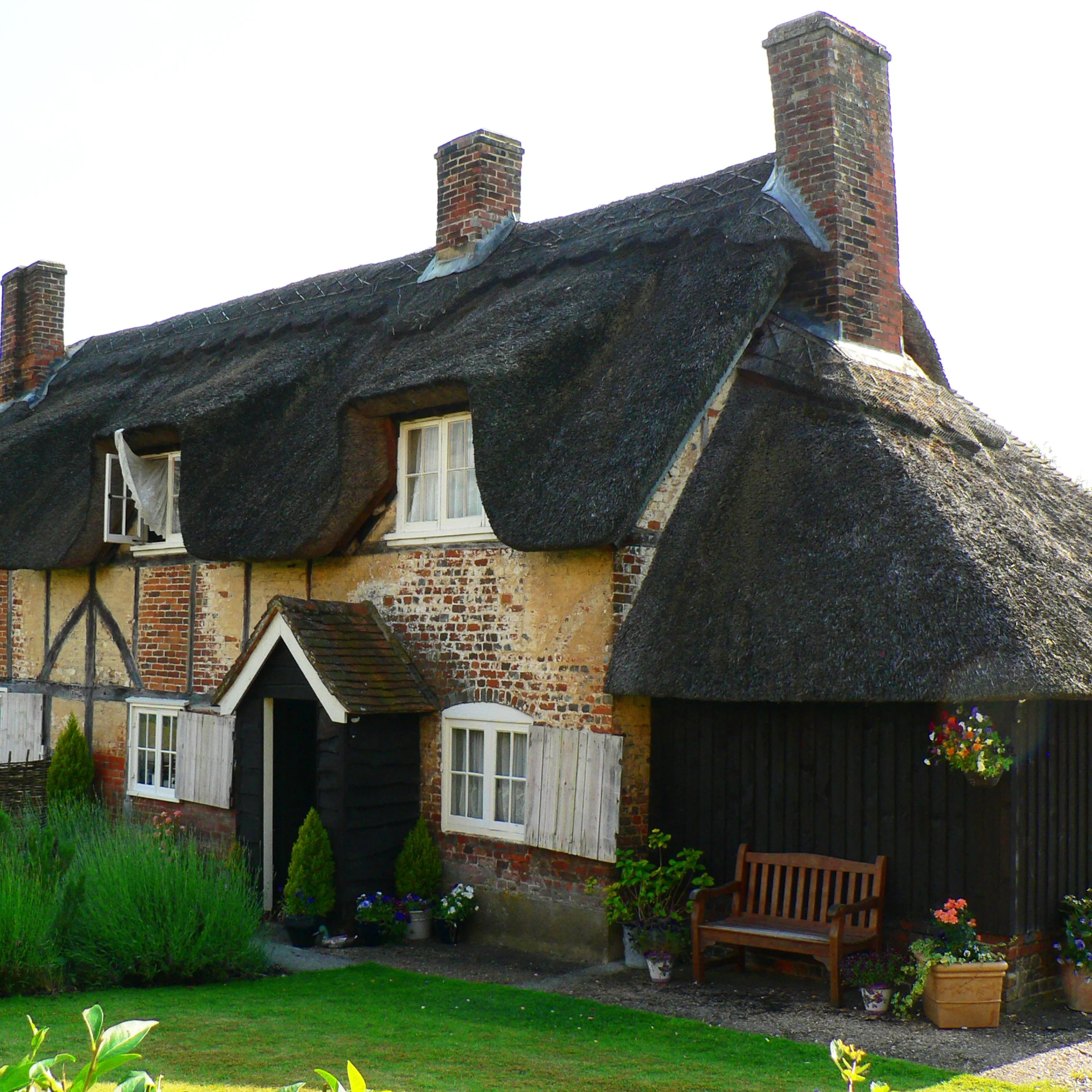 Front entrance elevation of thatched cottage extension created with the use of traditional materials to blend the old and new building structure for a complementing and comfortable design